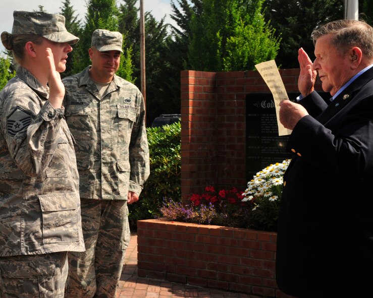 Master Sgt. Brenda Degnan, 62nd Maintenance Squadron, raises her right hand as she recites the Oath of Enlistment administered by retired Col. Joe Jackson, Medal of Honor recipient, July 29, 2011, at Joint Base-Lewis McChord, Wash. Tech. Sgt. Erik Degnan, Degnan's husband, watched the re-enlistment ceremony. (U.S. Air Force Photo/Staff Sgt. Frances Kriss)