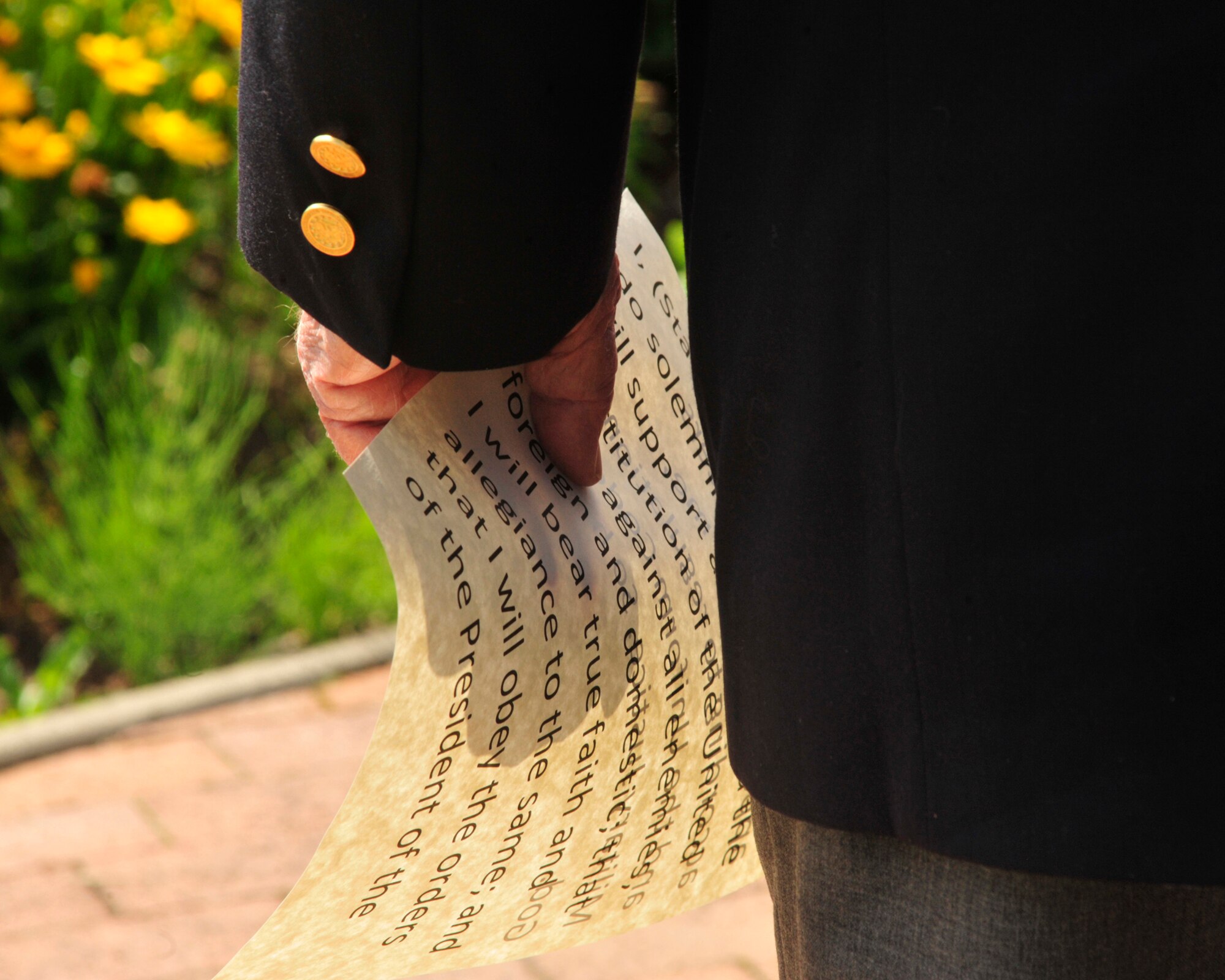 Retired Col. Joe Jackson, Medal of Honor recipient, holds a piece of paper stating the Oath of Enlistment July 29, 2011, at Joint Base-Lewis McChord, Wash. Jackson administered the oath to Master Sgt. Brenda Degnan, 62nd Maintenance Squadron, who re-enlisted for five years. (U.S. Air Force Photo/Staff Sgt. Frances Kriss)