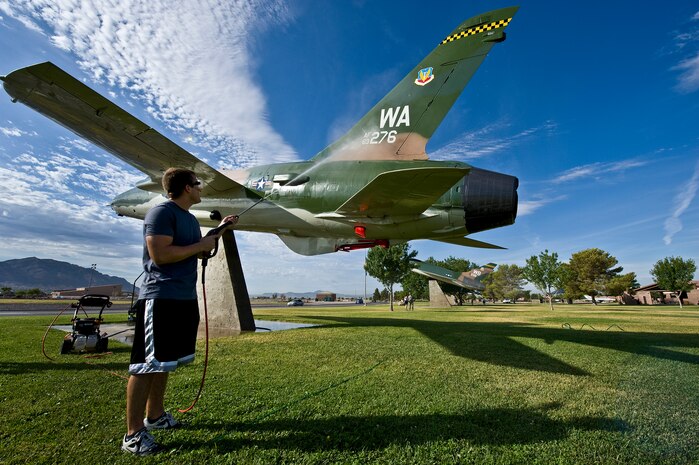 U.S. Air Force Airman 1st Class Benjamin Abshire, 57th Aircraft Maintenance Squadron crew chief, power washes the back of a F-105 Thunderchief static display July 29, 2011, at Nellis Air Force Base, Nev. Airman Abshire is among a group of volunteers from the 57th and 757th Aircraft Maintenance Squadrons that washed the airplane static displays for the first time in a new plan to wash them once every quarter. (U.S. Air Force photo by Airman 1st Class George Goslin/Released)