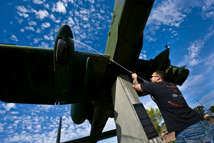 U.S. Air Force Senior Airman Matthew Byous, 57th Aircraft Maintenance Squadron crew chief, power washes the bottom of an A-10 Thunderbolt static display July 29, 2011 at Nellis Air Force Base, Nev. Senior Airman Byous is among a group of volunteers from the 57th and 757th Aircraft Maintenance Squadrons that washed the airplane static displays for the first time in a new plan to wash them once every quarter. (U.S. Air Force photo by Airman 1st Class George Goslin/Released)
