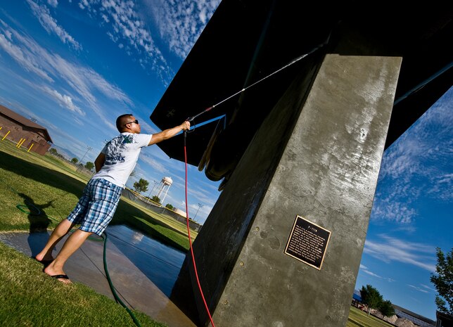U.S. Air Force Staff Sgt. Jonathan Pelaez, 757th Aircraft Maintenance Squadron crew chief, power washes the bottom of a F-105A Thunderchief static display July 29, 2011, at Nellis Air Force Base, Nev. Sgt. Pelaez is among a group of volunteers from the 57th and 757th Aircraft Maintenance Squadrons that washed the airplane static displays for the first time in a new plan to wash them once every quarter. (U.S. Air Force photo by Airman 1st Class George Goslin/Released)