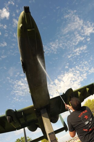 U.S. Air Force Senior Airman Matthew Byous, 57th Aircraft Maintenance Squadron crew chief, power washes the bottom of an A-10 Thunderbolt II static display July 29, 2011, at Nellis Air Force Base, Nev. Senior Airman Byous is among a group of volunteers from the 57th and 757th Aircraft Maintenance Squadrons tasked with cleaning and inspecting the static display aircraft at Freedom park for the first time, the goal is to create a regular cleaning schedule for the aircraft to help prevent corrosion and pro-long their lifespan. (U.S. Air Force photo by Staff Sgt. Taylor Worley/Released)