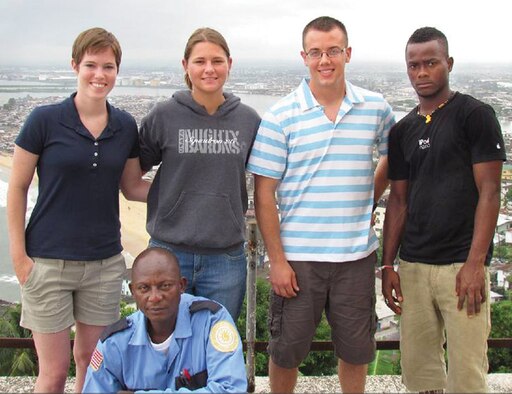 From left, Cadet 1st Class Megan Holt, U.S. Military Academy, Cadet 1st Class Dayna Grant, Cadet Squadron 26, Cadet 1st Class Brian Solmonson, USMA, and Clay Johnson, a Liberian student and guide. In front is Peter, a security guard who showed the cadets around the Ducor Palace Hotel in Monrovia, Liberia. (Courtesy Photo)