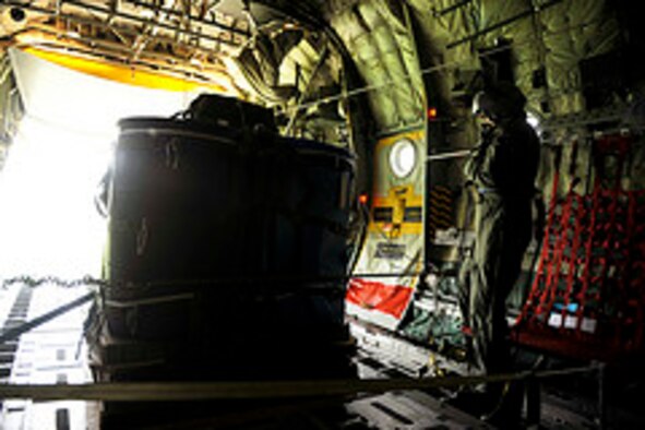 Pakistan air force Chief Warrant Officer Abdul Majid, Number 6 Air Transport Squadron, prepares to drop a container delivery system bundle during a training mission aboard a C-130E Hercules to prepare for Rodeo 2011 at Joint Base Lewis-McChord, Wash., July 22, 2011.  Air Mobility Rodeo is the U.S. Air Force's and Air Mobility Command’s premier international combat skill and flying operations competition designed to develop and improve techniques, procedures and interoperability, while optimizing international mobility partnerships and enhancing mobility operations.  (U.S. Air Force Photo Staff Sgt. Eric Harris)