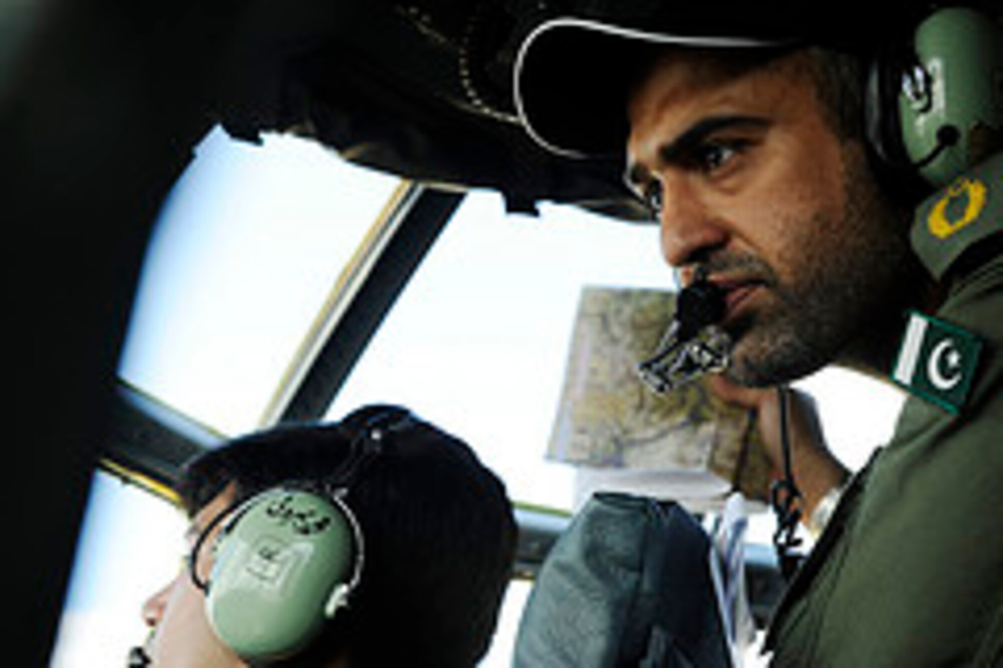 Pakistan air force Squadron Leader Abdullah Naveed, Number 6 Air Transport Squadron, navigates aboard a C-130E Hercules during a training mission to prepare for Rodeo 2011 at Joint Base Lewis-McChord, Wash., July 22, 2011.  Air Mobility Rodeo is the U.S. Air Force's and Air Mobility Command’s premier international combat skill and flying operations competition designed to develop and improve techniques, procedures and interoperability, while optimizing international mobility partnerships and enhancing mobility operations.  (U.S. Air Force Photo Staff Sgt. Eric Harris)