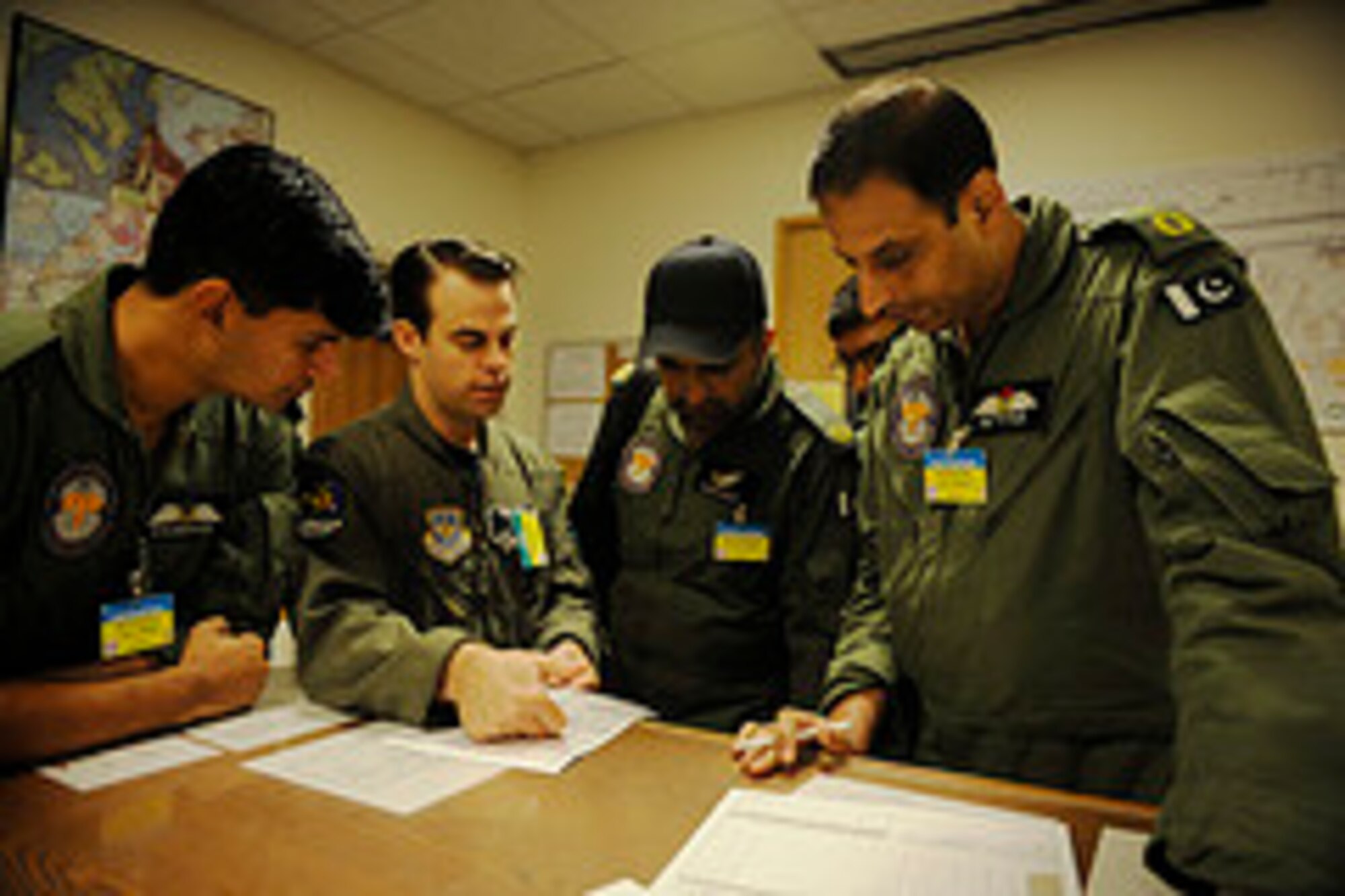 Members of the Pakistan air force conduct a pre-mission briefing before a training mission to prepare for Rodeo 2011 at Joint Base Lewis-McChord, Wash., July 22, 2011.  Air Mobility Rodeo is the U.S. Air Force's and Air Mobility Command’s premier international combat skill and flying operations competition designed to develop and improve techniques, procedures and interoperability, while optimizing international mobility partnerships and enhancing mobility operations. (U.S. Air Force Photo Staff Sgt. Eric Harris)