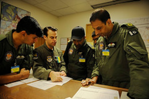 Members of the Pakistan air force conduct a pre-mission briefing before a training mission to prepare for Rodeo 2011 at Joint Base Lewis-McChord, Wash., July 22, 2011.  Air Mobility Rodeo is the U.S. Air Force's and Air Mobility Command’s premier international combat skill and flying operations competition designed to develop and improve techniques, procedures and interoperability, while optimizing international mobility partnerships and enhancing mobility operations. (U.S. Air Force Photo Staff Sgt. Eric Harris)