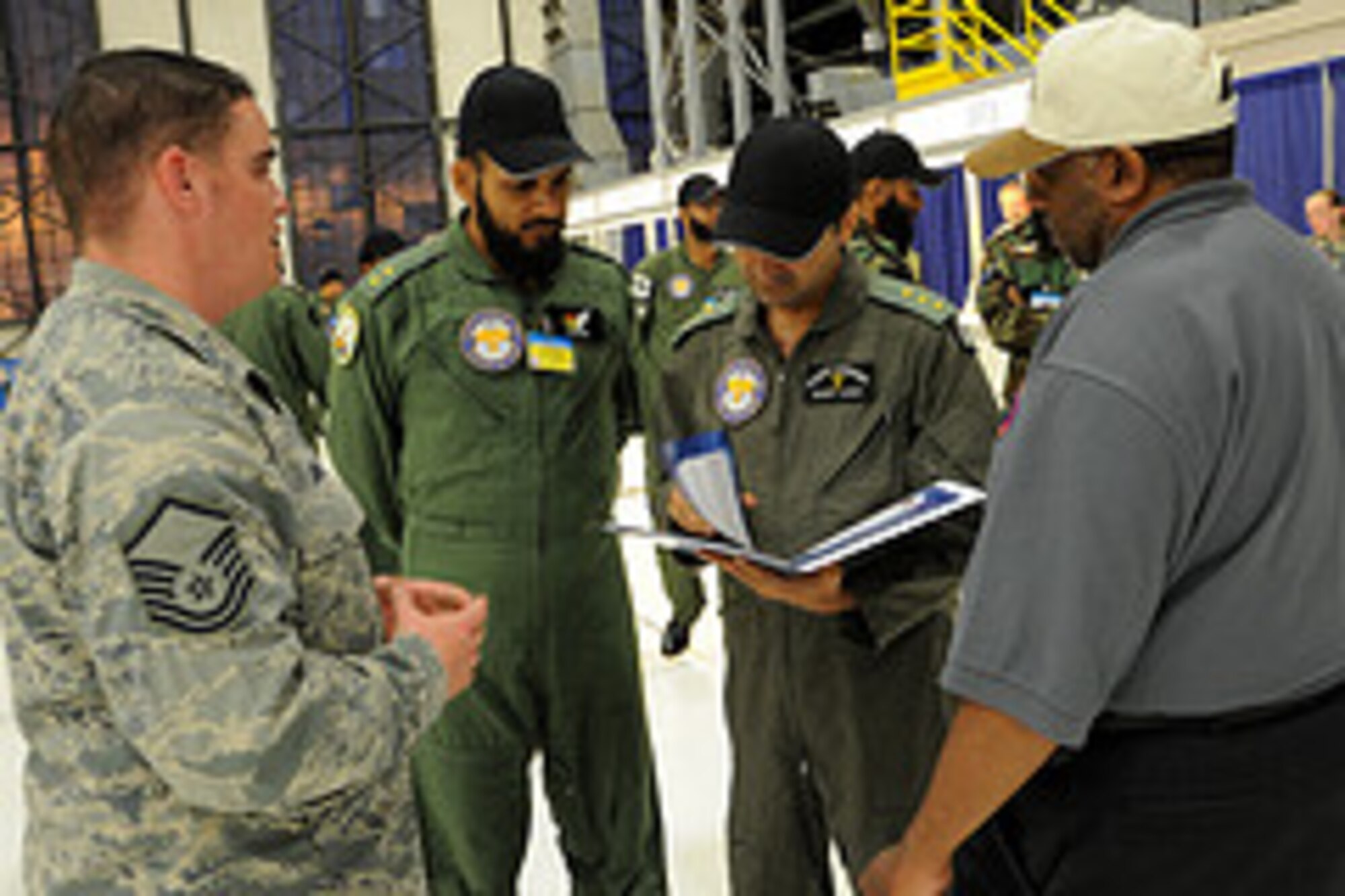 U.S. Air Force members assist Pakistan Air Force members with inprocessing Rodeo on July 19, 2011, at Joint Base Lewis-McChord, Wash. Rodeo is the U.S. Air Force's and Air Mobility Command's premier international combat skills and flying operations competition designed to develop and improve techniques, procedures, and interoperability, while optimizing international mobility  partnerships and enhancing mobility operations. (U.S. Air Force photo by Tech. Sgt. Christine Jones/Released)