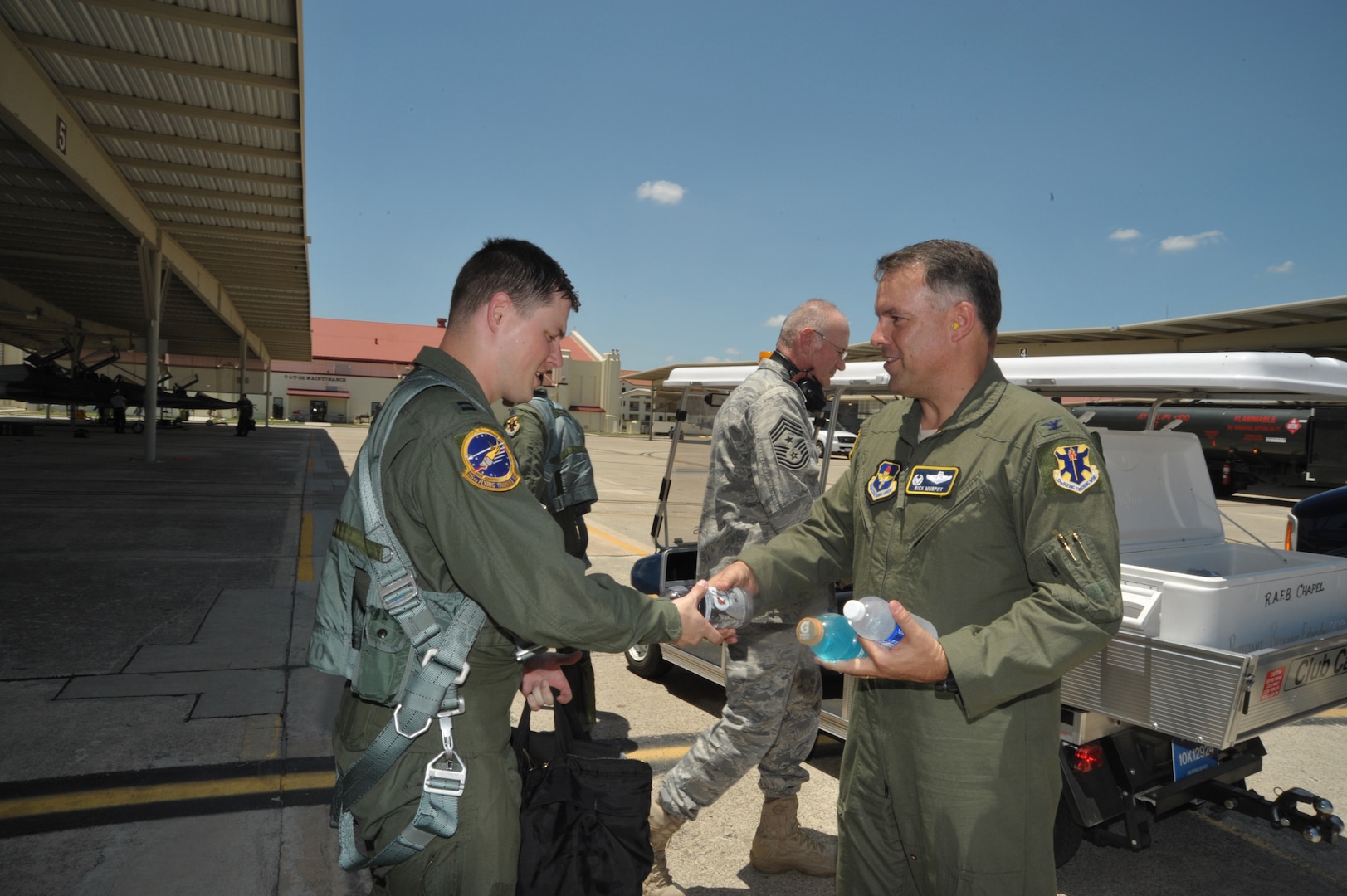 Col Richard Murphy, 12th Flying Training Wing commander, gives a sports drink to Capt. Jered Yankech, 560th Flying Training Squadron, as part of the chaplain staff weekly flightline visitations. (U.S. Air Force photo/Airman 1st Class Alexis Siekert) (released)