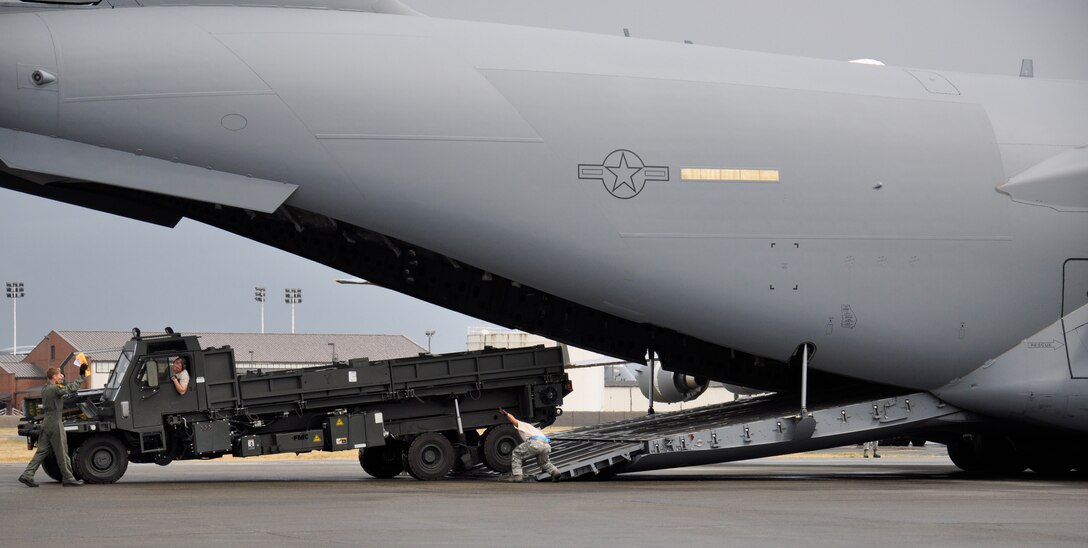 The 89th Aerial Port Squadron here paired up with a March AFB C-17 team during the Engines Running On/Offload competition during the 2011 Air Mobility Command Rodeo Competition which took place at Joint Base Lewis-McChord, Wash. from July 24-29. The 89th Aerial Port Squadron conducted a cargo on/offload which simulated a cargo drop occurring in the Area of Respnsibility.  Teams were required to on/offload a HMMWV (Humvee) with an attached trailer and a 25-ton Next Generation Small Loader (NGSL).  The competition was timed and teams were scored on speed, team work, communication with the aircrew and securing the cargo load. (U.S. Air Force photo by Major Michelle Lai)