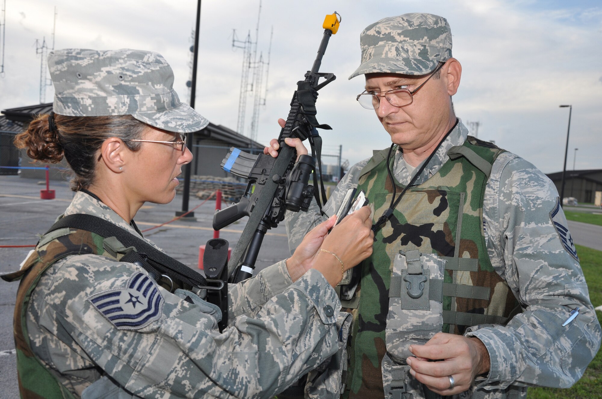 A member of the 315th Security Forces Squadron, 315th Airlift Wing checks identification at the entry control point during the Operational Readiness Exercise at Gulfport Training Center, Miss., July 28. Participants from the 628th Air Base Wing, 437th Airlift Wing and the 315th Airlift Wing all participated in the event to prepare for their upcoming Operational Readiness Inspection. (U.S. Air Force photo/Tech. Sgt. Scott Mathews)