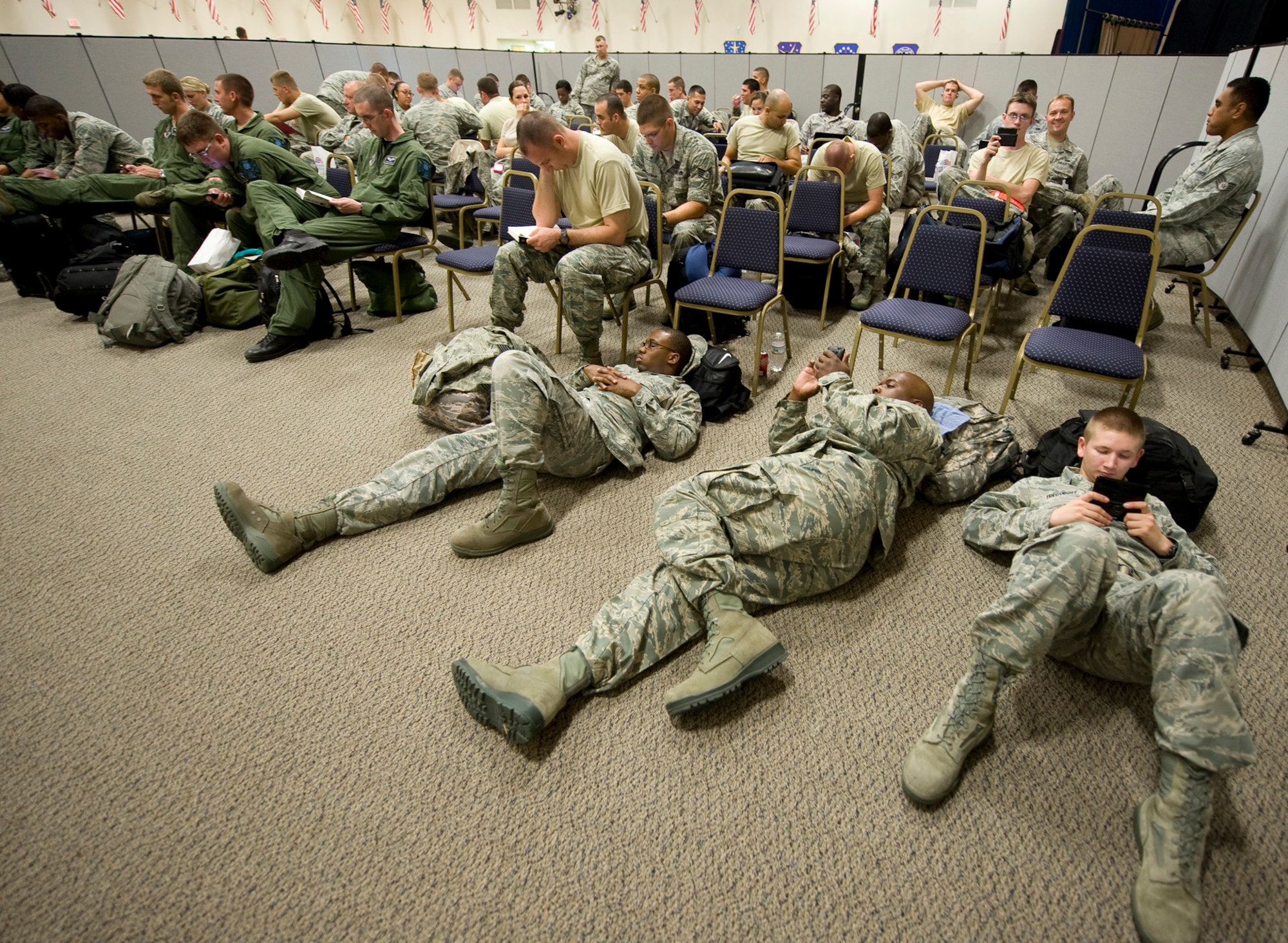 Airmen wait to leave for Guam after processing the deployment line in Hoban Hall on Barksdale Air Force Base, La., Aug. 4. Air Force Global Strike Command Airmen routinely deploy to Guam in support of the continuous bomber presence in the area. (U.S. Air Force photo/Senior Airman Chad Warren)(RELEASED)