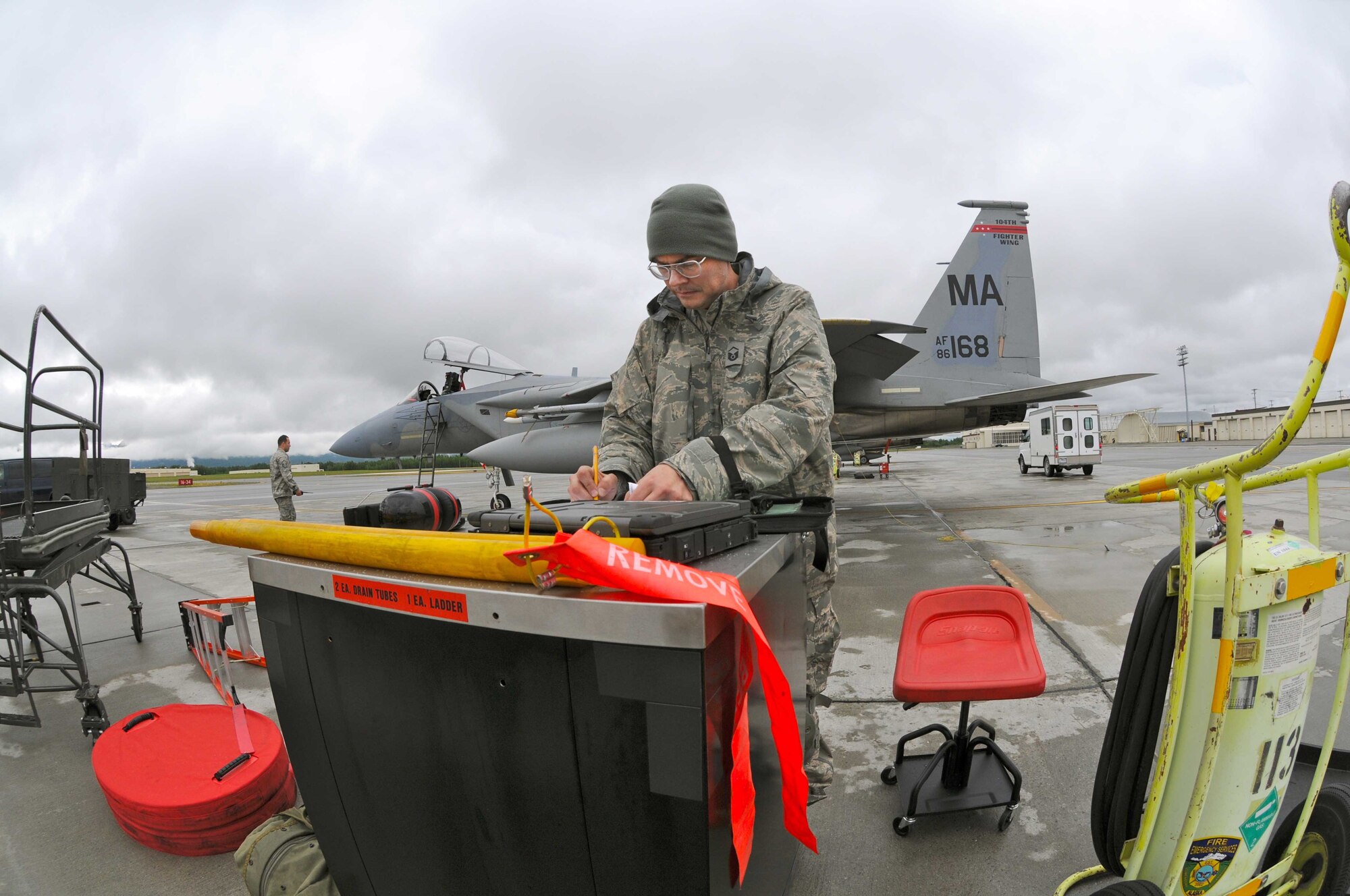 Master Sergeant Turner Fowks, 104th Fighter Wing crew chief, completing necessary maintenance forms after the Mass. Air National Guard F-15 completed a training flight while deployed to Joint Base Elmendorf-Richardson, Alaska. (U.S. Air Force Photo by: Technical Sergeant, Anthony M. Mutti)