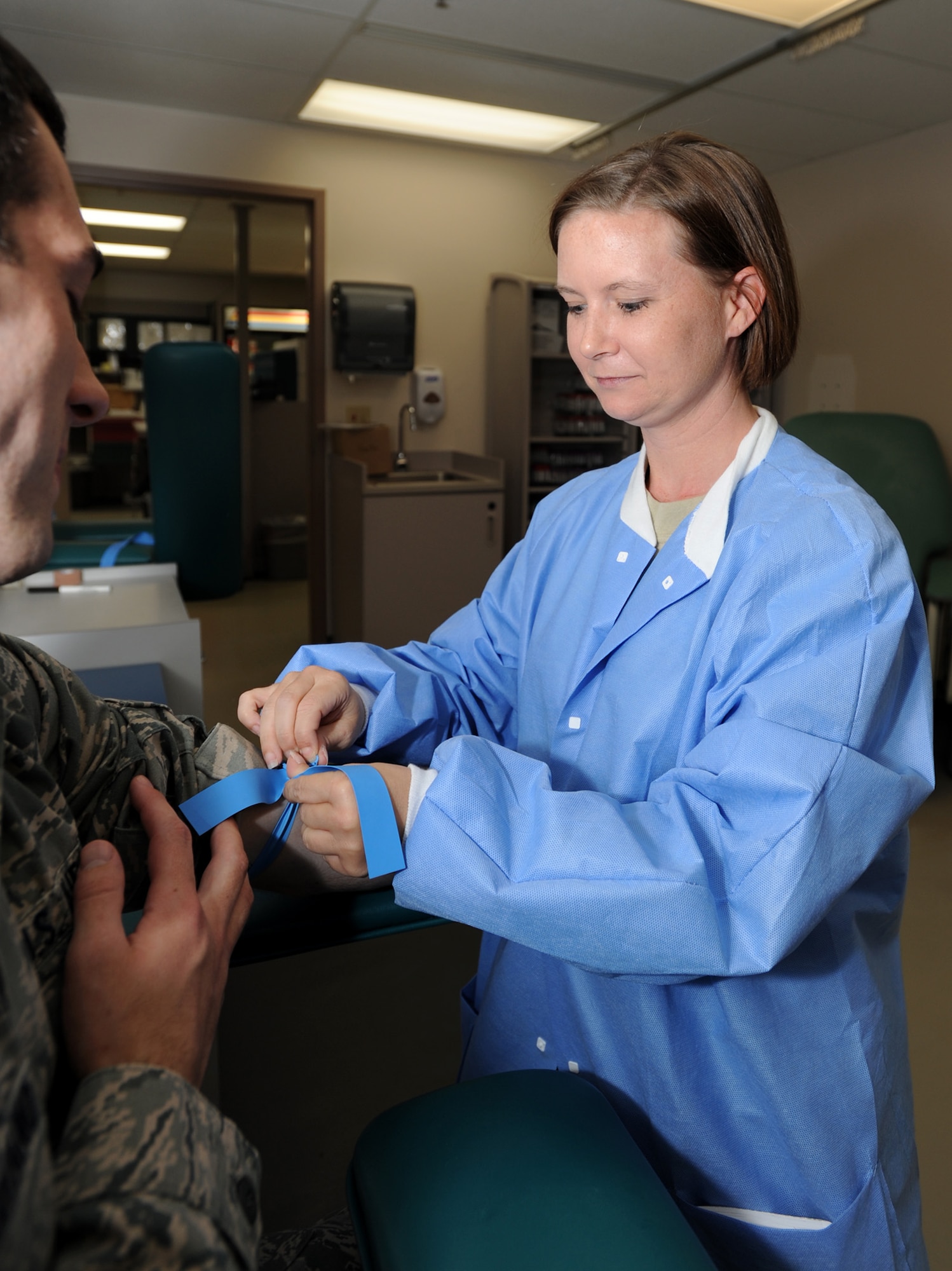 Tech. Sgt. Belinda Durbin, 22nd Medical Support Squadron laboratory services NCOIC, places a tourniquet on a patient’s arm before drawing blood.  Durbin is responsible for daily operations of the clinical laboratory, in accordance with the standards of the College of American Pathologists, and supervises seven technicians who perform an average of 130,000 lab tests a year.  (U.S. Air Force/ Airman 1st Class Laura L. Valentine)