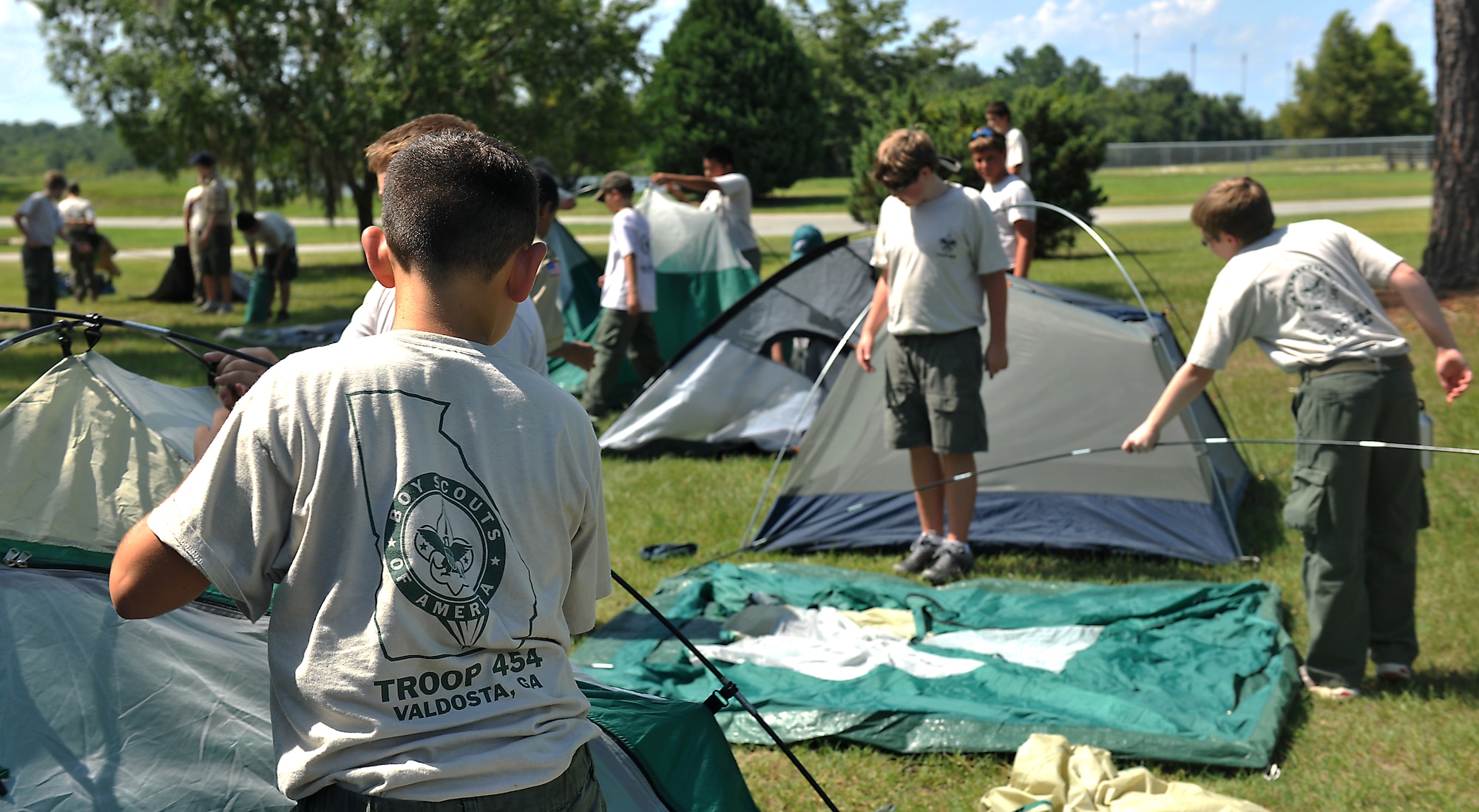 Boy Scouts from Troop 454 set up tents at Mission Lake for their overnight visit at Moody Air Force Base, Ga., July 31, 2011. The Scouts visited Moody to earn their aviation merit badges. Scouts earned the badge by learning about different aircraft and their uses, as well as the different type of engine operations. (U.S. Air Force photo by Airman 1st Class Joshua Green/Released)

