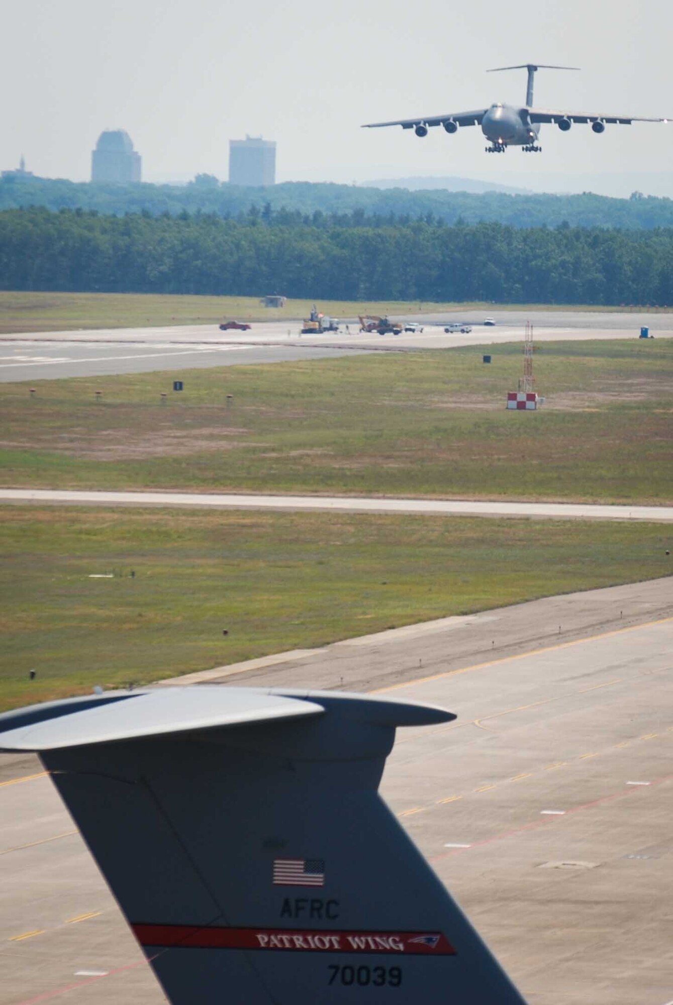 Col. Robert Swain Jr., 439th Airlift Wing commander, flew his final C-5 mission Aug. 3. Dozens of onlookers awaited the conclusion of the commander's fini flight, including his wife, Diane Swain, who used a large hose from the Westover Fire Department to douse her husband shortly after he stepped down the crew ladder from the C-5. The fini flight adds to the colonel's more than 3,500 hours flying C-5s and A-10s -- including 51 combat missions over Southwest Asia. Swain is the first pilot to score an air-to-air kill in an A-10 Thunderbolt II, when he downed an Iraqi helicopter during Operation Desert Storm. He will relinquish command of the 439th AW Aug. 6 to Col. Steven Vautrain. (US Air Force photo/SrA Kelly Galloway)