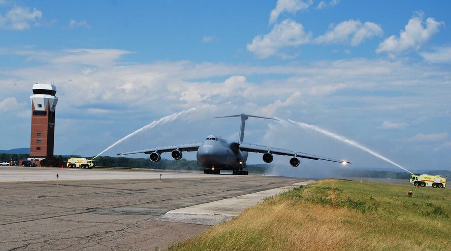 Col. Robert Swain Jr., 439th Airlift Wing commander, flew his final C-5 mission Aug. 3. Dozens of onlookers awaited the conclusion of the commander's fini flight, including his wife, Diane Swain, who used a large hose from the Westover Fire Department to douse her husband shortly after he stepped down the crew ladder from the C-5. The fini flight adds to the colonel's more than 3,500 hours flying C-5s and A-10s -- including 51 combat missions over Southwest Asia. Swain is the first pilot to score an air-to-air kill in an A-10 Thunderbolt II, when he downed an Iraqi helicopter during Operation Desert Storm. He will relinquish command of the 439th AW Aug. 6 to Col. Steven Vautrain. (US Air Force photo/Master Sgt. Andrew Biscoe)