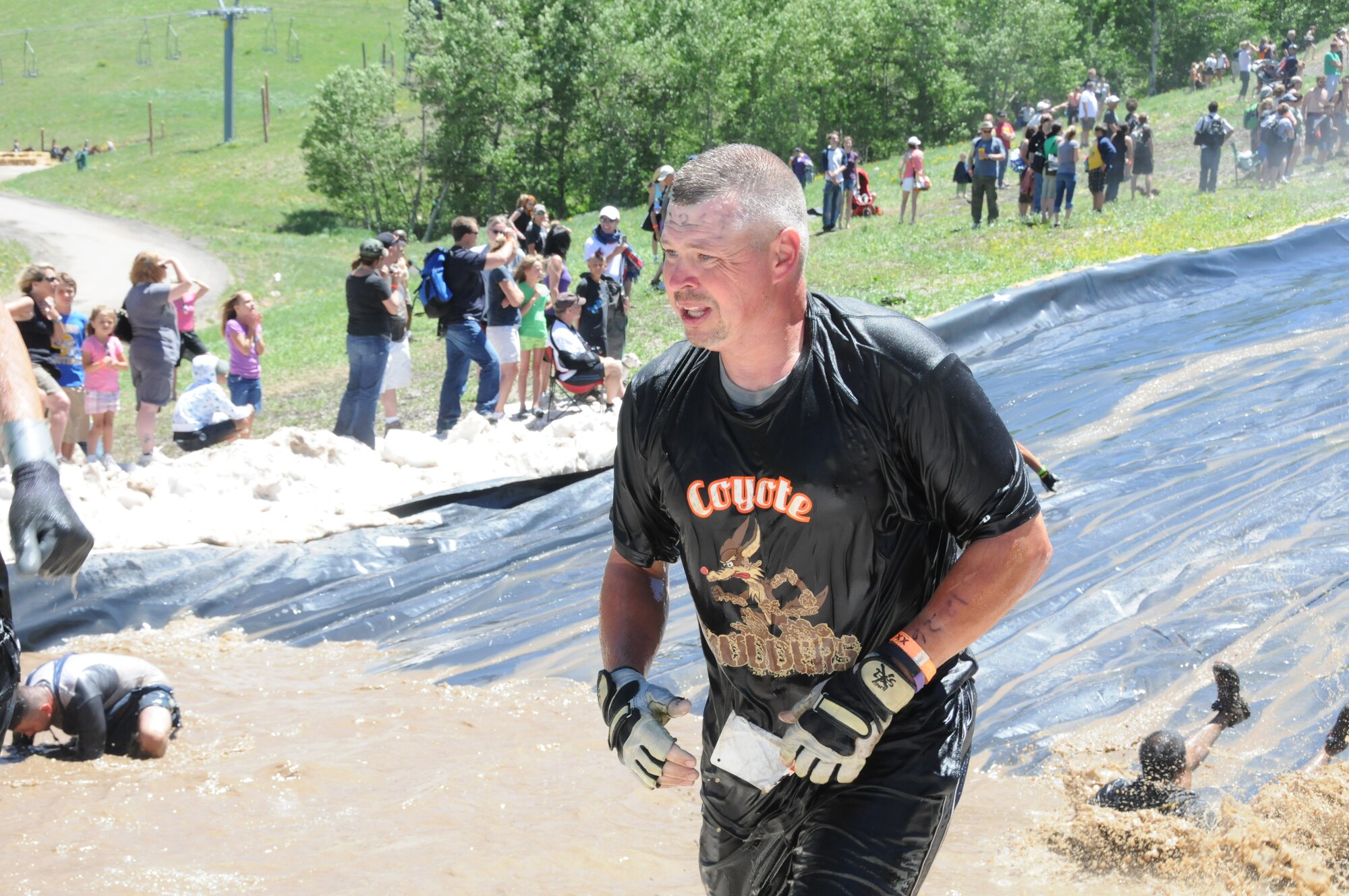 Senior Master Sgt. Brian Willard catches his breath after completing the final obstacle. (photos by Master Sgt. Allen Pickert)