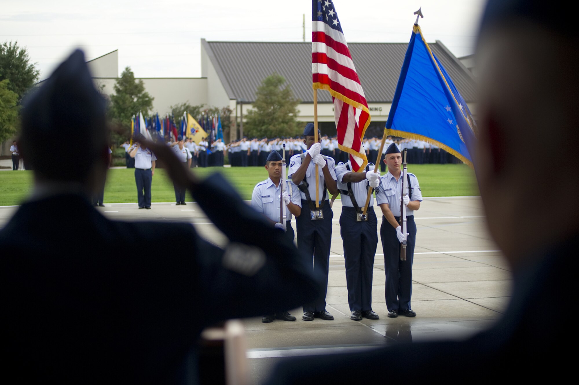 Airmen salute during the playing of the national anthem at the 81st Training Group change of command ceremony July 28 on the parade field.  Col. Lynn Connett turned over command to Col. Maureen Smith.  Smith is a recent graduate of the Industrial College of the Armed Forces, Fort McNair, Washington, D.C.  Connett returns to the Pentagon as deputy director for manpower and personnel plans and integration for the Air Staff.  (U.S. Air Force photo by Adam Bond)