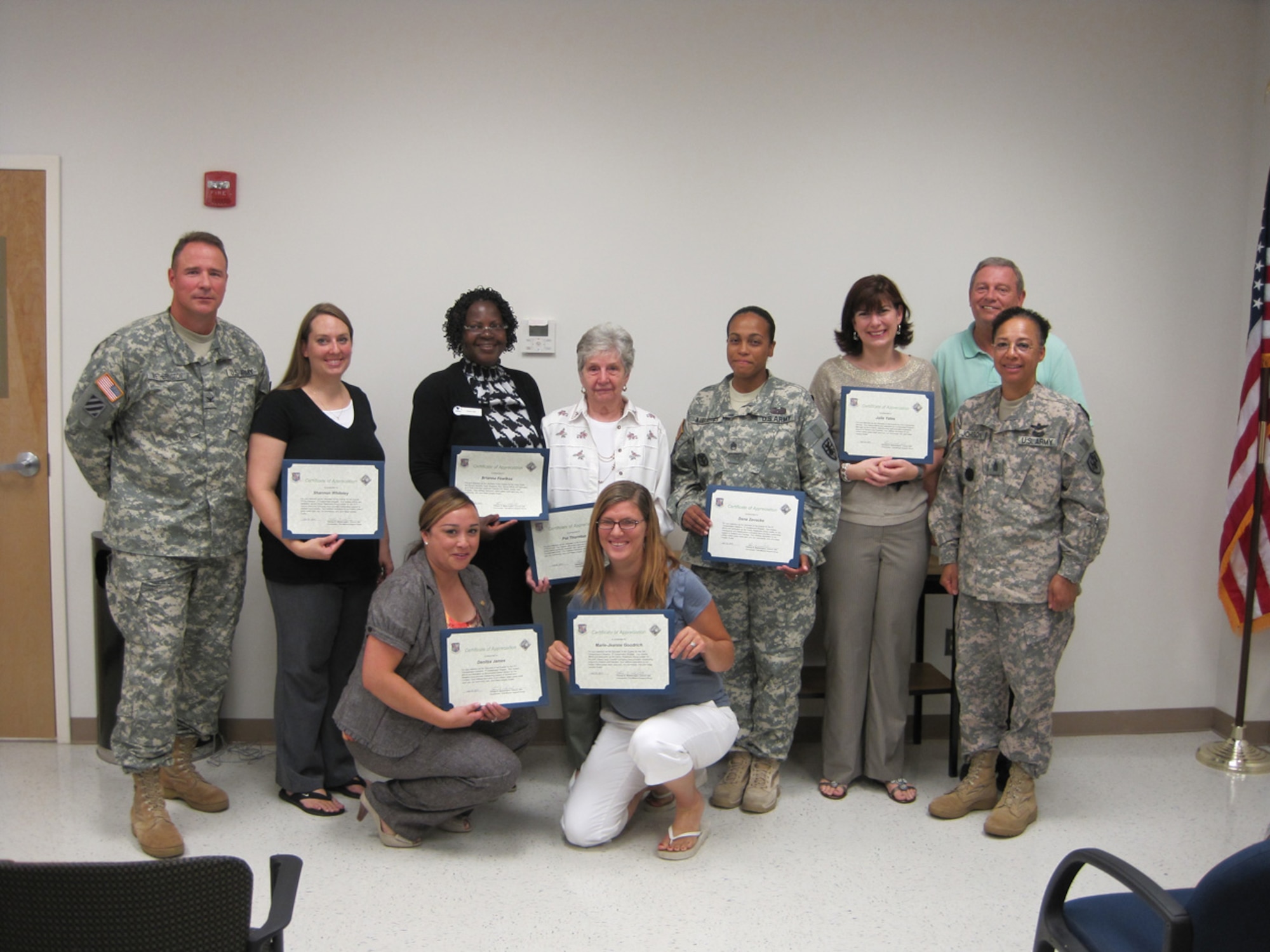 Back row from left is Col. Thomas Wetherington, 733rd Mission Support Group commander; Shannon Whiteley, Special Troops Battalion Volunteer of the Quarter; Gracie Little, stood in for Brianna Fowlkes, Child, Yout and School Services Volunteer of the Quarter; Pat Thornton, Spouses Club Volunteer of the Quarter; Staff Sgt. Carida Wannemacher, stood in for Dana Zevecke, 6th Transportation Battalion Volunteer of the Quarter; Julie Yates, Soldier and Family Readiness Volunteer of the Quarter; John Volkers, Force Support Division director, Command Sgt. Maj. Carolyn Johnson, 733 MSG command sergeant major. Front row from is Danitza James, 24th Trans. Bn. Volunteer of the Quarter; and Marie-Jean Goodrich, 10th Trans. Bn. Volunteer of the Quarter. (Courtesy photo)