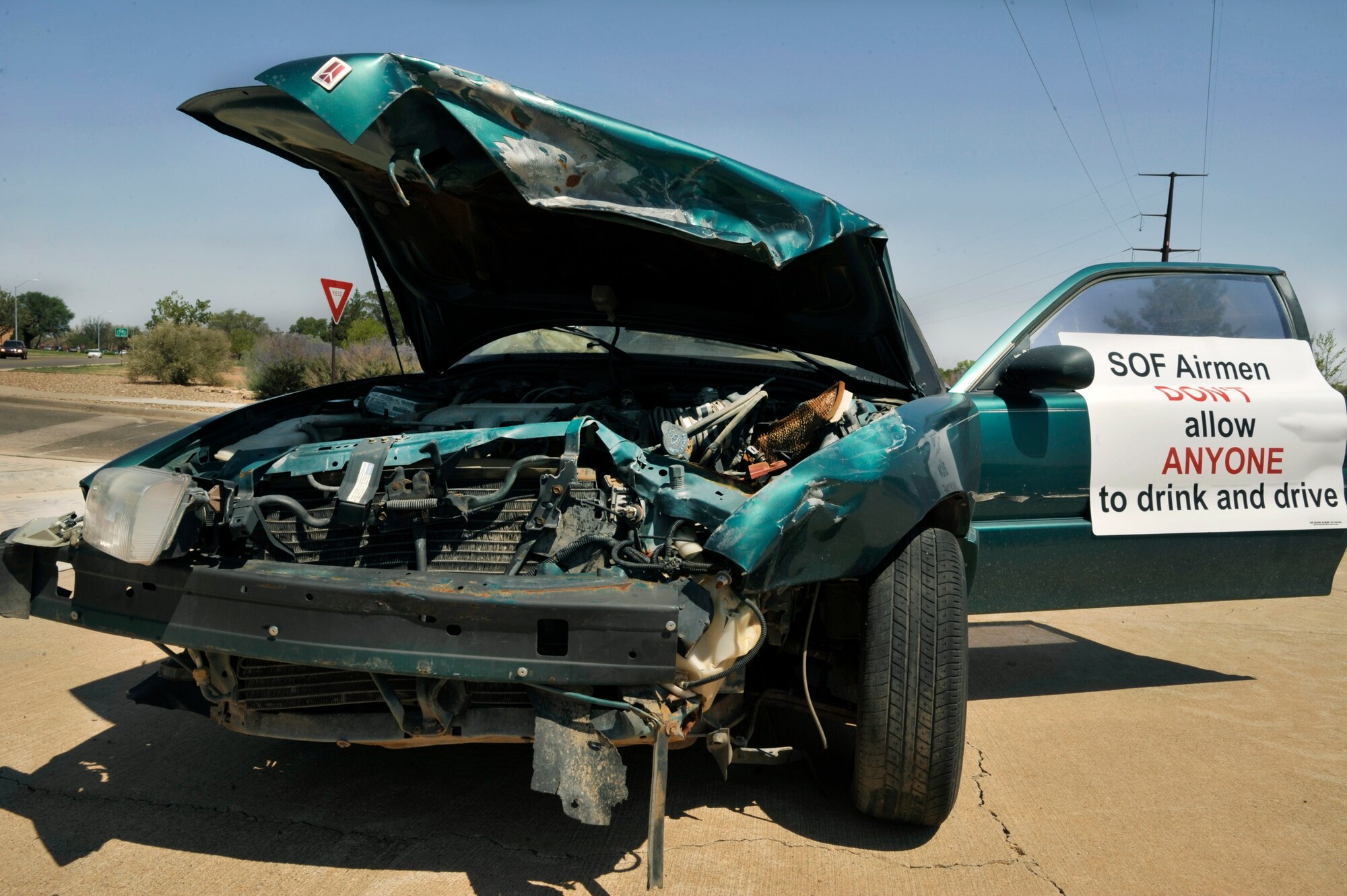 The 27th Special Operation Security Force Squadron and the 27th Special Operations Logistics Readiness Squadron put a wrecked vehicle on display at Cannon Air Force Base, N.M., July 21, 2011. A sign on the vehicle states that Special Operations Forces Airmen don’t allow anyone to drink and drive. (U.S. Air Force photo by Airman 1st Class Ericka Engblom)    