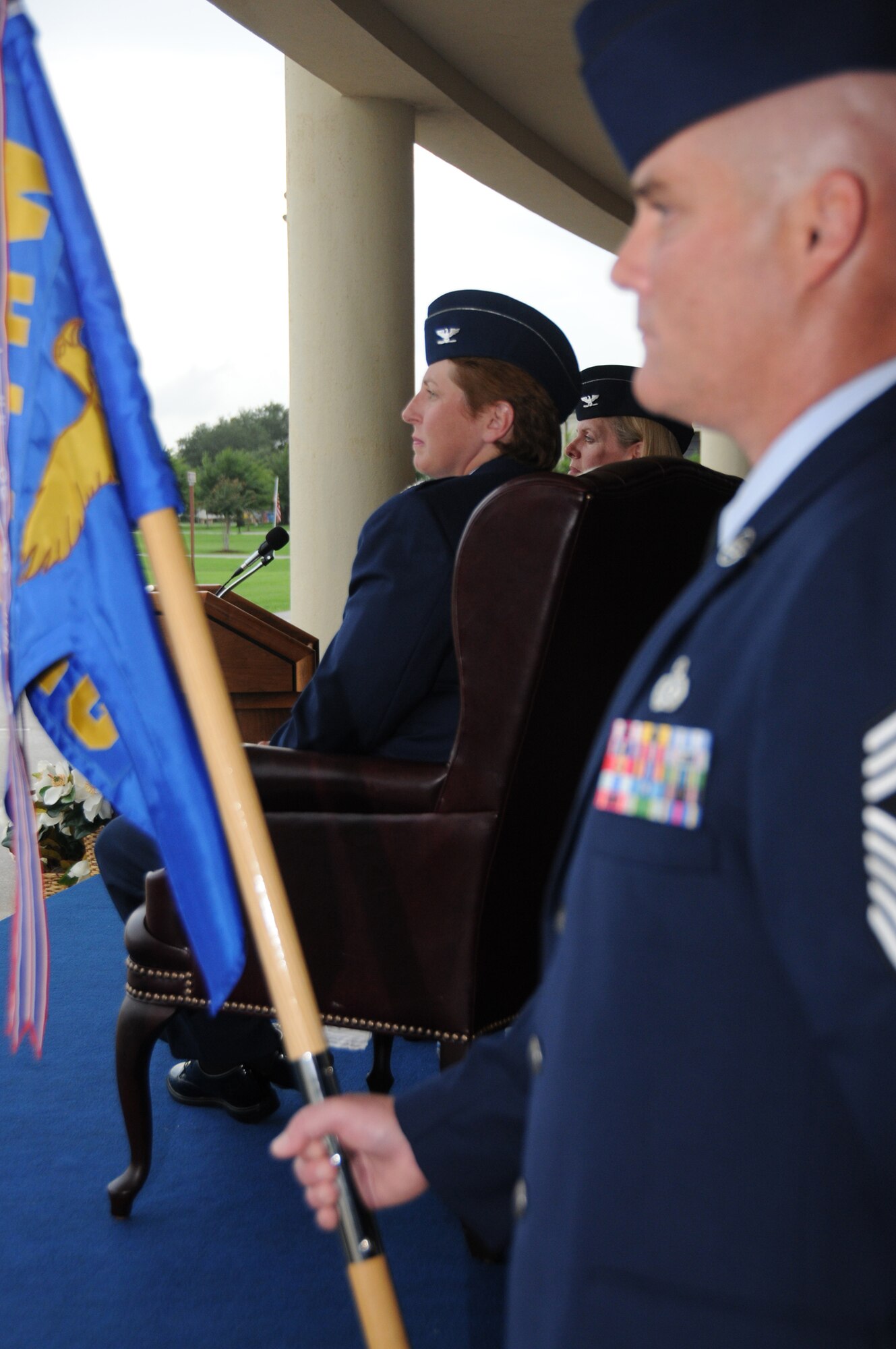 Col. Maureen Smith, left, the new 81st Training Group commander, watches the student parade during the  change of command ceremony July 28 on the parade field while Chief Master Sgt. Glen Usherwood, 81st TRG superintendent, holds the 81st TRG guidon.  (U.S. Air Force photo by Kemberly Groue)