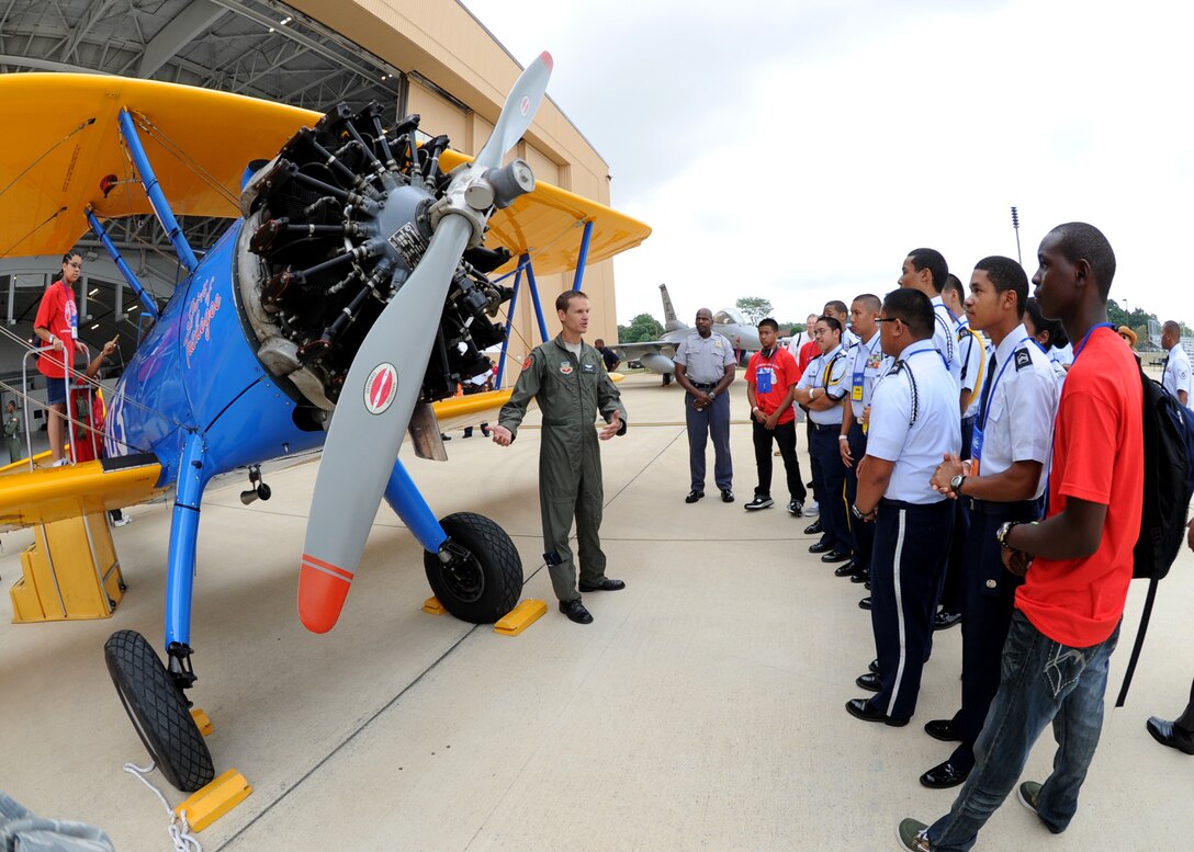 Capt. Matthew Quy, 12th Reconnaissance Squadron, Pilot, Beale Air Force Base, Cali., speaks with Junior Reserve Officer Training School Cadets, Oxon Hill High School, Md., about the PT-13 Tuskegee Airmen original training aircraft static display during the 2011 Tuskegee Airmen, Inc. National Convention Youth Day at Joint Base Andrews Aug. 4. Students in grades 8-12 came here to interact with service members and aviation personnel.  (U.S. Air Force photo/ Staff Sgt. Nichelle Anderson)