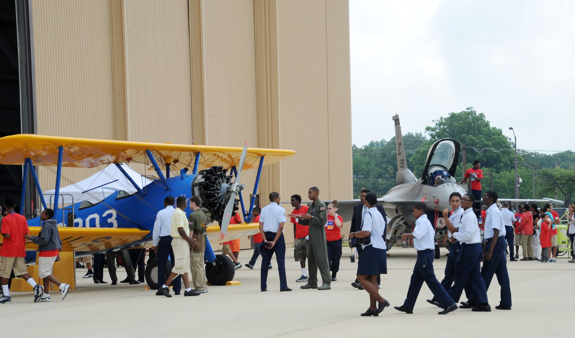 Students interact with service members during the 2011 Tuskegee Airmen, Inc. National Convention Youth Day at Joint Base Andrews, Md., Aug. 4. The students viewed various static displays, including the PT-13 Tuskegee Airmen original training aircraft. (U.S. Air Force photo/Staff Sgt. Nichelle Anderson)