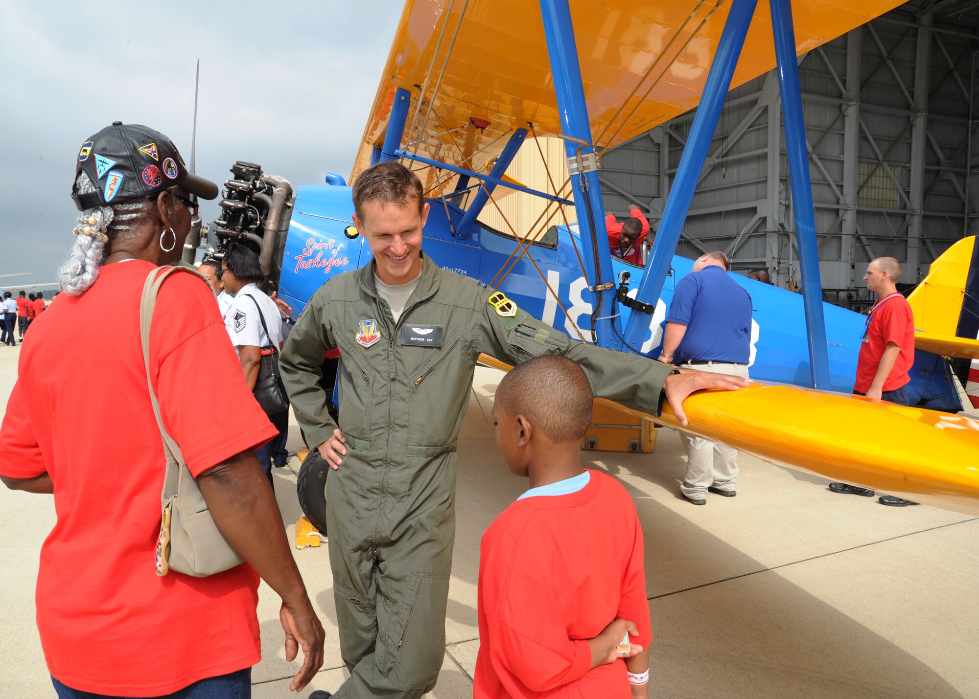 Capt. Matthew Quy, 12th Reconnaissance Squadron, Pilot, Beale Air Force Base, Calif., speaks with Pearlene Franklin and grandson Chandler Ross, student at Rollin Elementary School, Augusta, Ga. about the PT-13 Tuskegee Airmen original training aircraft static display during the 2011 Tuskegee Airmen, Inc. National Convention Youth Day at Joint Base Andrews Aug. 4.  (U.S. Air Force photo/ Staff Sgt. Nichelle Anderson)