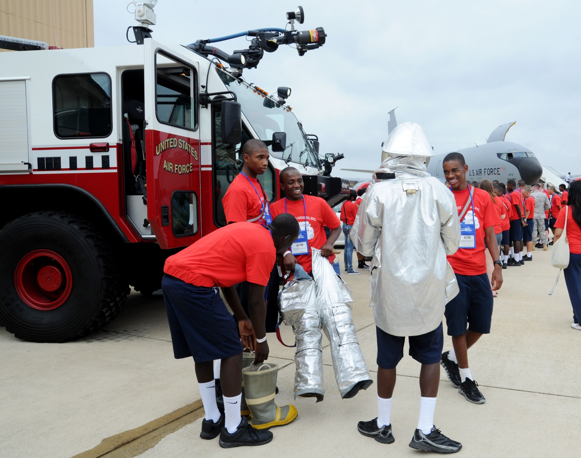 Students try on fire suits during the 2011 Tuskegee Airmen, Inc. National Convention Youth Day at Joint Base Andrews, Md., Aug. 4. Students in grades 8-12 came here to interact with service members and aviation personnel. (U.S. Air Force photo/ Staff Sgt. Nichelle Anderson)
