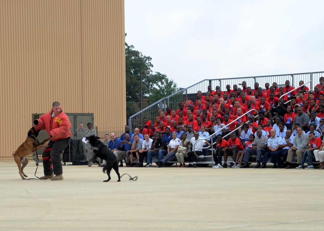 Staff Sgt. Benjamin Lee, 11th Security Forces Squadron Military Working Dog Handler and Military Working Dogs Lennox and Lana perform a demonstration during the 2011 Tuskegee Airmen, Inc. National Convention Youth Day at Joint Base Andrews, Md., Aug. 4. Students in grades 8-12 came here to interact with service members and aviation personnel.  This year marks the 70th anniversary of America’s first black pilots and support personnel, the Tuskegee Airmen. (U.S. Air Force photo/ Staff Sgt. Nichelle Anderson)  