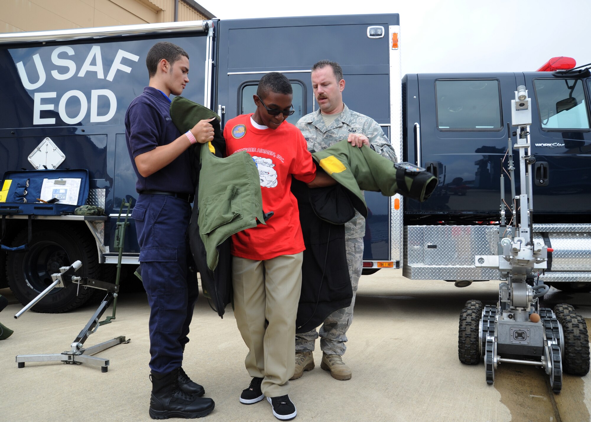 Brian Simmons, 11th grade student from Surrattsville High School Clinton, Md., tries on the 85-pound explosive ordinance disposal bomb suit during the 2011 Tuskegee Airmen, Inc. National Convention Youth Day at Joint Base Andrews, Md., Aug. 4. Students in grades 8-12 came here to interact with service members and aviation personnel.  This year marks the 70th anniversary of America’s first black pilots and support personnel, the Tuskegee Airmen. (U.S. Air Force photo/Staff Sgt. Nichelle Anderson)