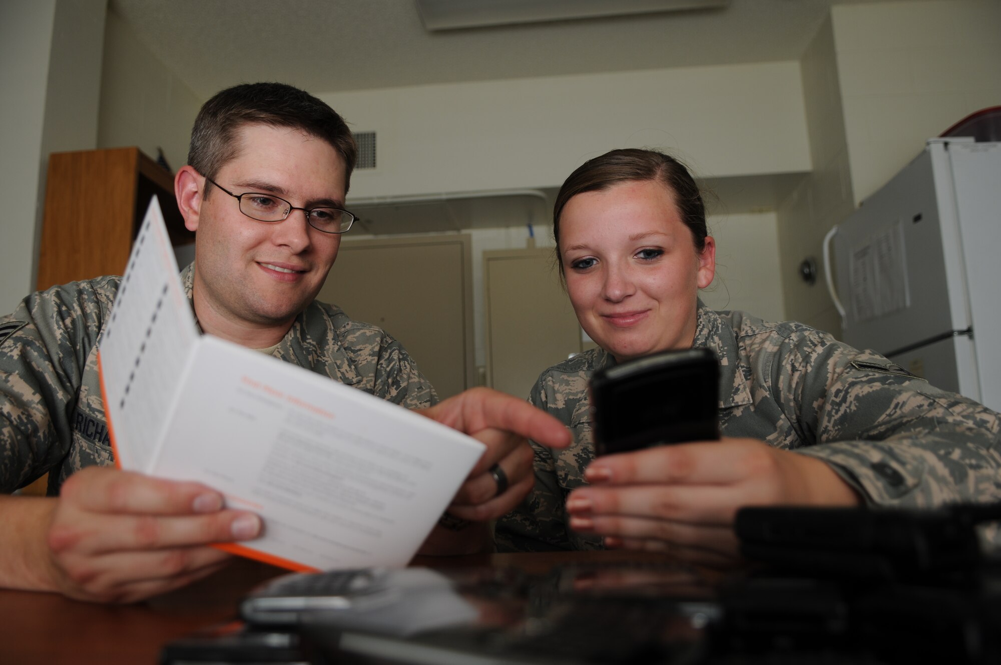 GOODFELLOW AIR FORCE BASE, Texas -- Staff Sgt. Nathan Richardson and Airman Morgan Overall, 17th Communication Squadron, conduct training on Blackberry communication devices July 27. Both airmen work to maintain personal wireless communication systems.  (U.S. Air Force photo/Senior Airman Heather L. Rodgers)
