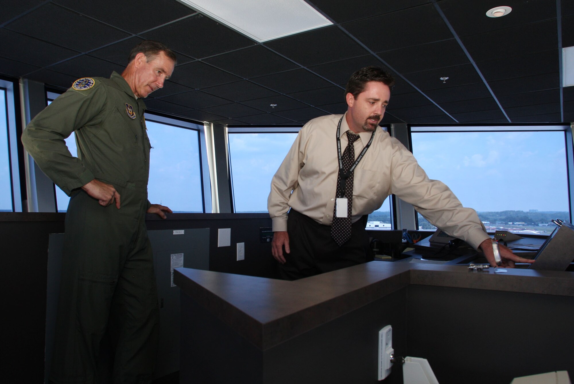 Maj. Gen. Gourley receives a briefing on Dobbins new air traffic control tower by David A. Seal, air traffic control manager, during a tour of the base Aug. 2. (U.S. Air Force Photo/Don Peek)