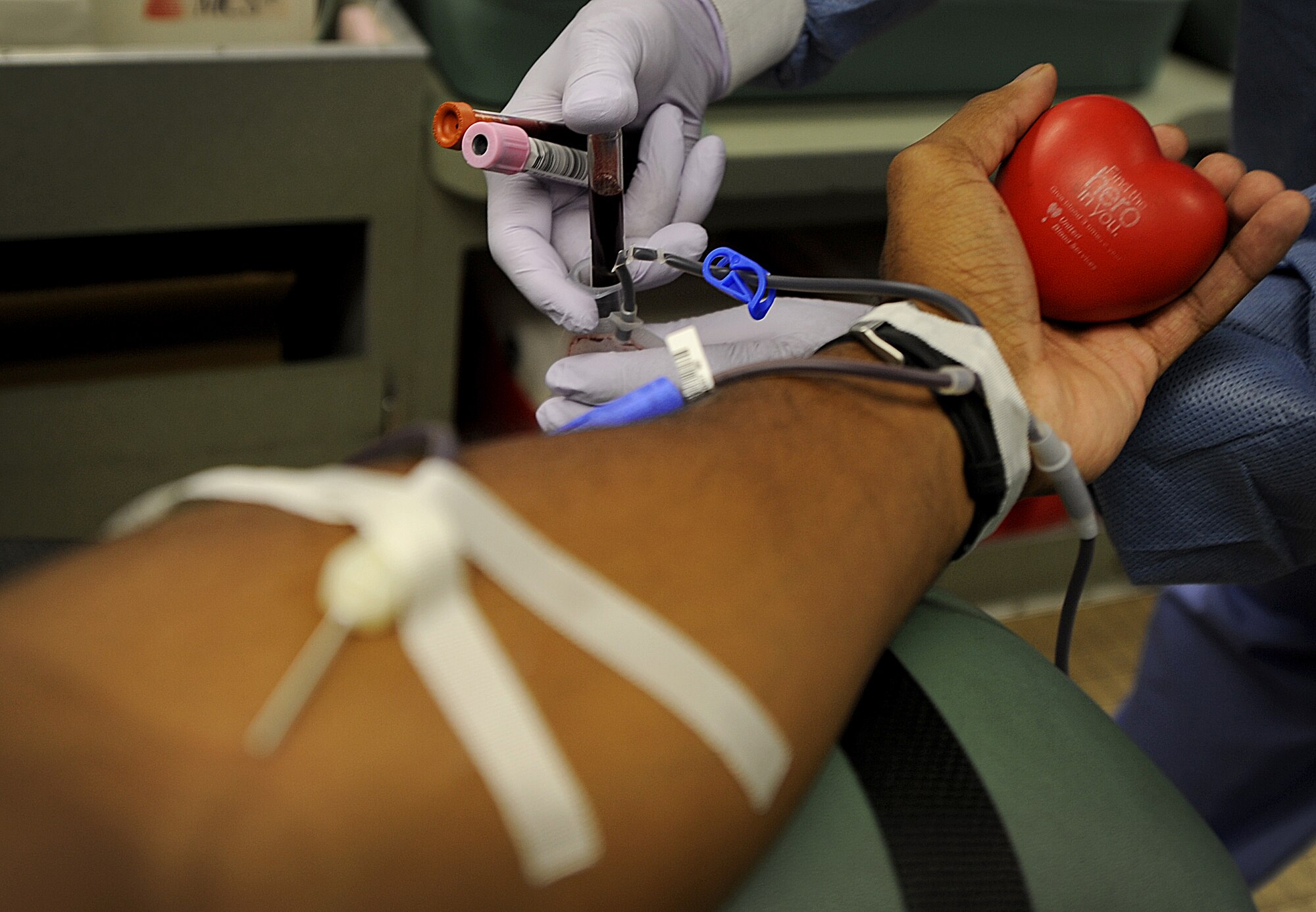 GOODFELLOW AIR FORCE BASE, Texas -- An Airman from the 17th Training Wing relaxes his hand while giving blood, as the donor care specialist takes samples for testing July 26. The airman is giving a whole blood donation, which can be separated into four different parts and possibly save several patients.  Goodfellow has donated more than 1,200 pints of blood so far this year to United Blood Services.  For information on upcoming blood drives, call (325) 223-7500.  (U.S. Air Force photo/Airman 1st Class Michael Smith)