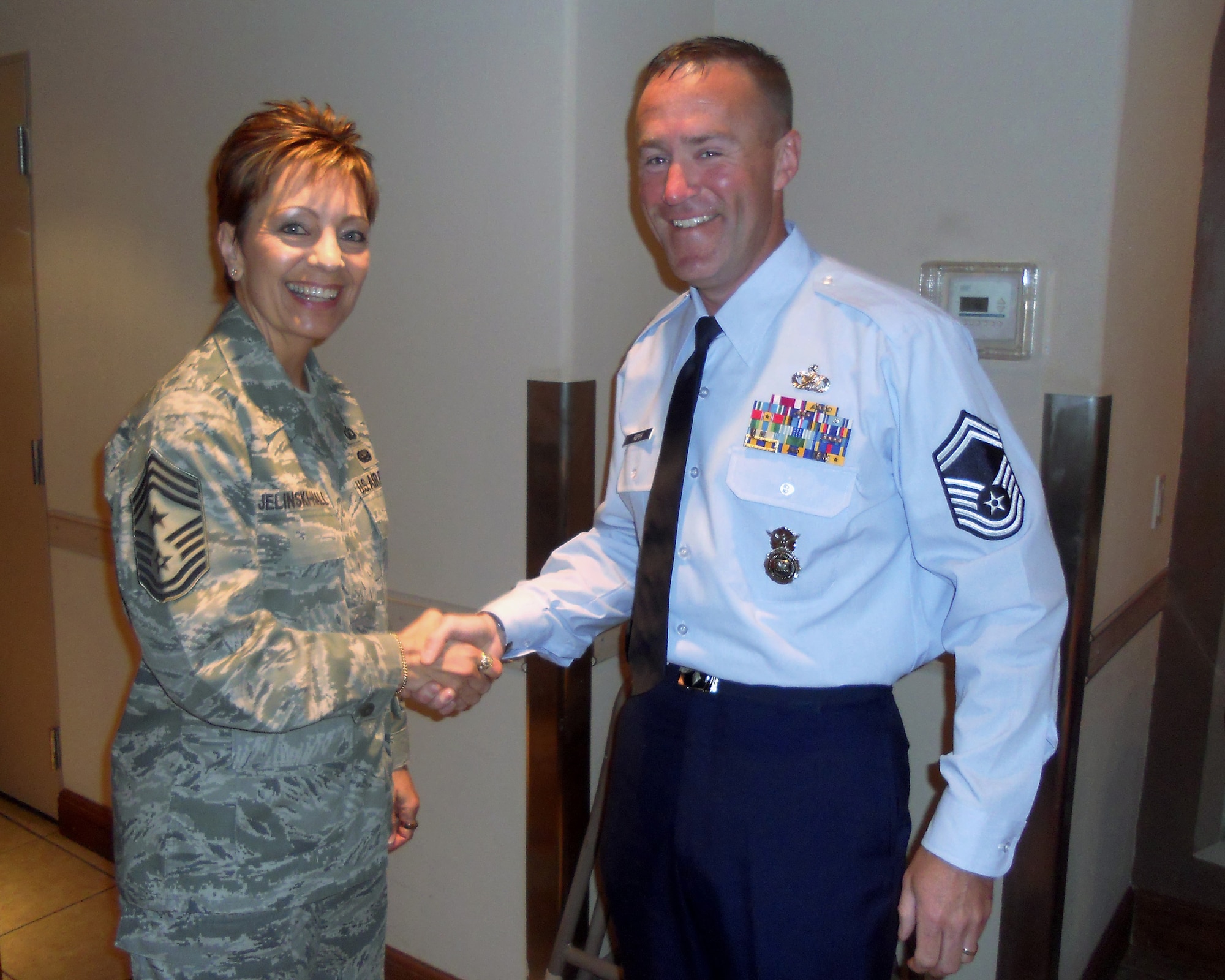 U.S. Air Force Command Chief Master Sgt. Denise Jelinski-Hall, Air Force Senior Enlisted Advisor hands Oregon Air National Guard Senior Master Sgt. Christopher Roper, one of her coins prior to his graduation ceremony from the U.S. Army Sergeant Major Academy on June 17, 2011 at Ft. Bliss, Tex. (Photograph courtesy of Senior Master Sgt. Christopher Roper)

