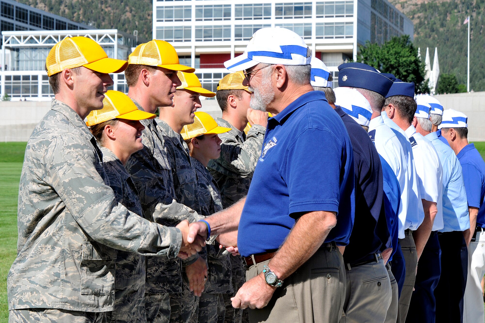 Members of the Air Force Academy's Class of 1975 congratulate cadets in the Class of 2015 on their formal acceptance into the Cadet Wing during the Acceptance Day Parade Aug. 3, 2011. The Class of 1975 is the legacy class for the new freshmen. (U.S. Air Force photo/Megan Davis)