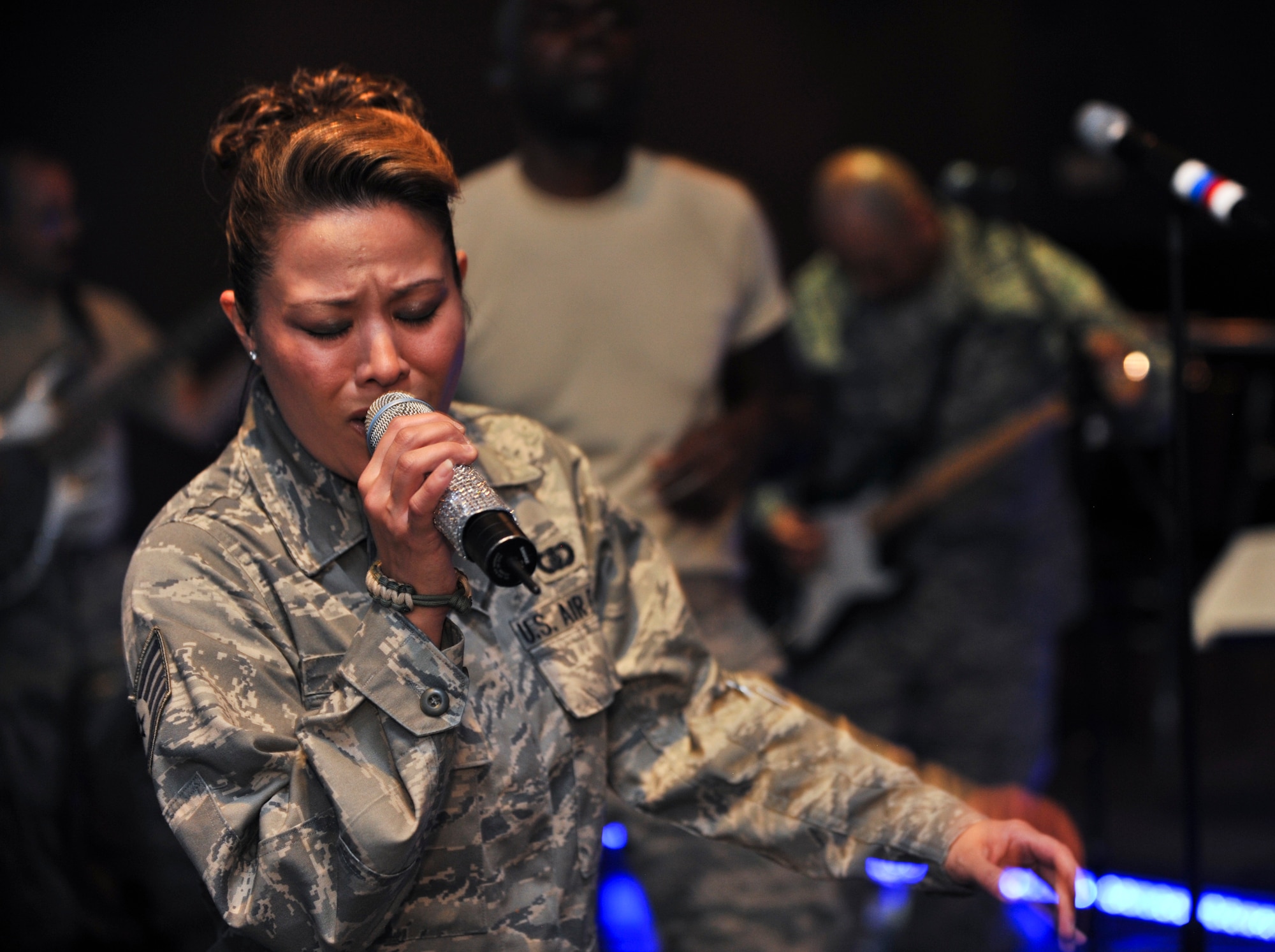 Staff Sgt. Angie Johnson, U.S. Air Forces Central Command Expeditionary Band “Sidewinder” vocalist, performs at an undisclosed location in Southwest Asia, July 29, 2011. The AFCENT Band “Sidewinder” is deployed from the Missouri Air National Guard. (U.S. Air Force photo/Senior Airman Paul Labbe)