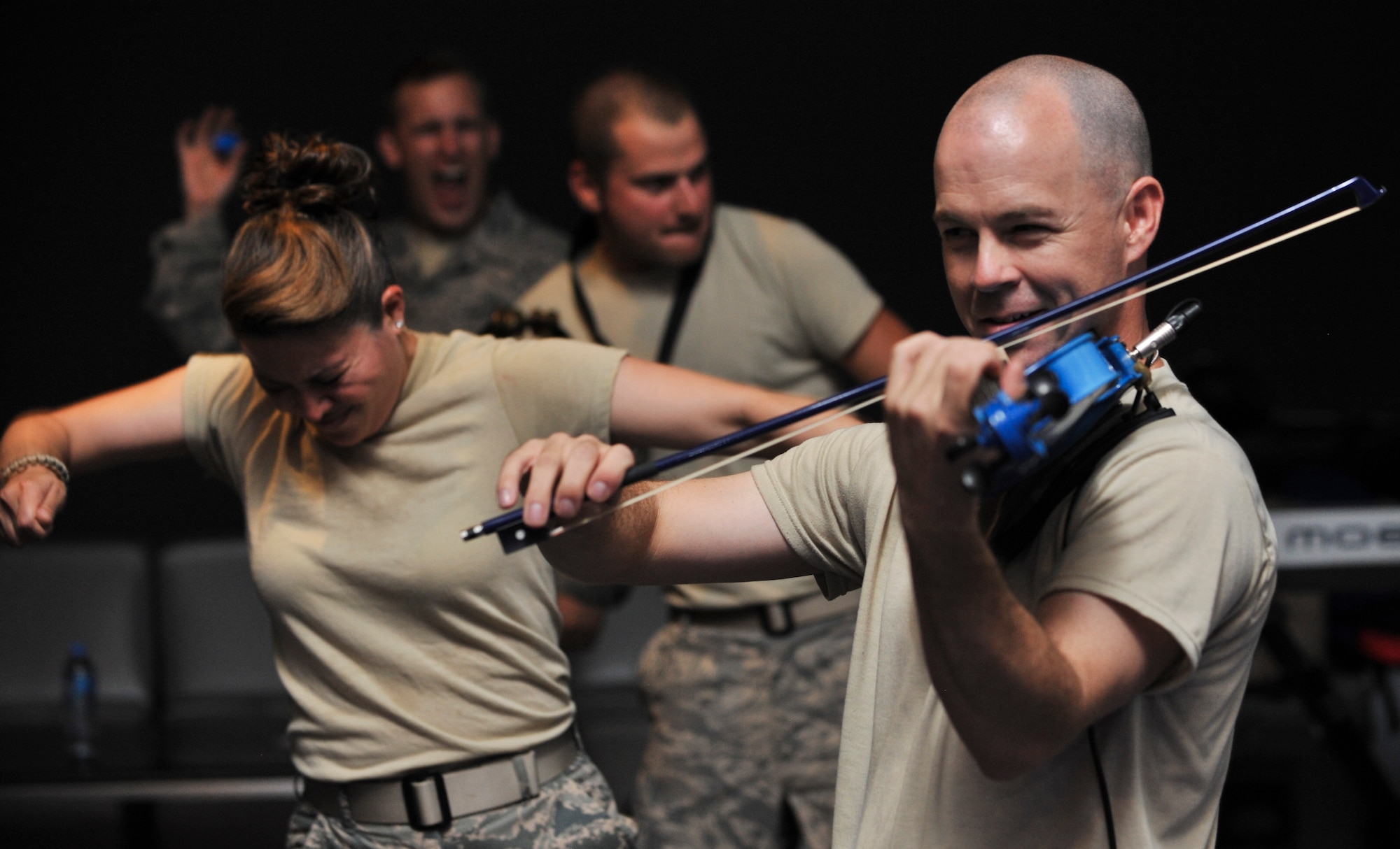 Capt. John Arata, U.S. Air Forces Central Command Expeditionary Band “Sidewinder” officer in charge, performs at an undisclosed location in Southwest Asia, July 29, 2011. “Sidewinder” conducts similar shows around the Area of Responsibility to boost morale of deployed Airmen.  The band is deployed from the Missouri Air National Guard. (U.S. Air Force photo/Senior Airman Paul Labbe)