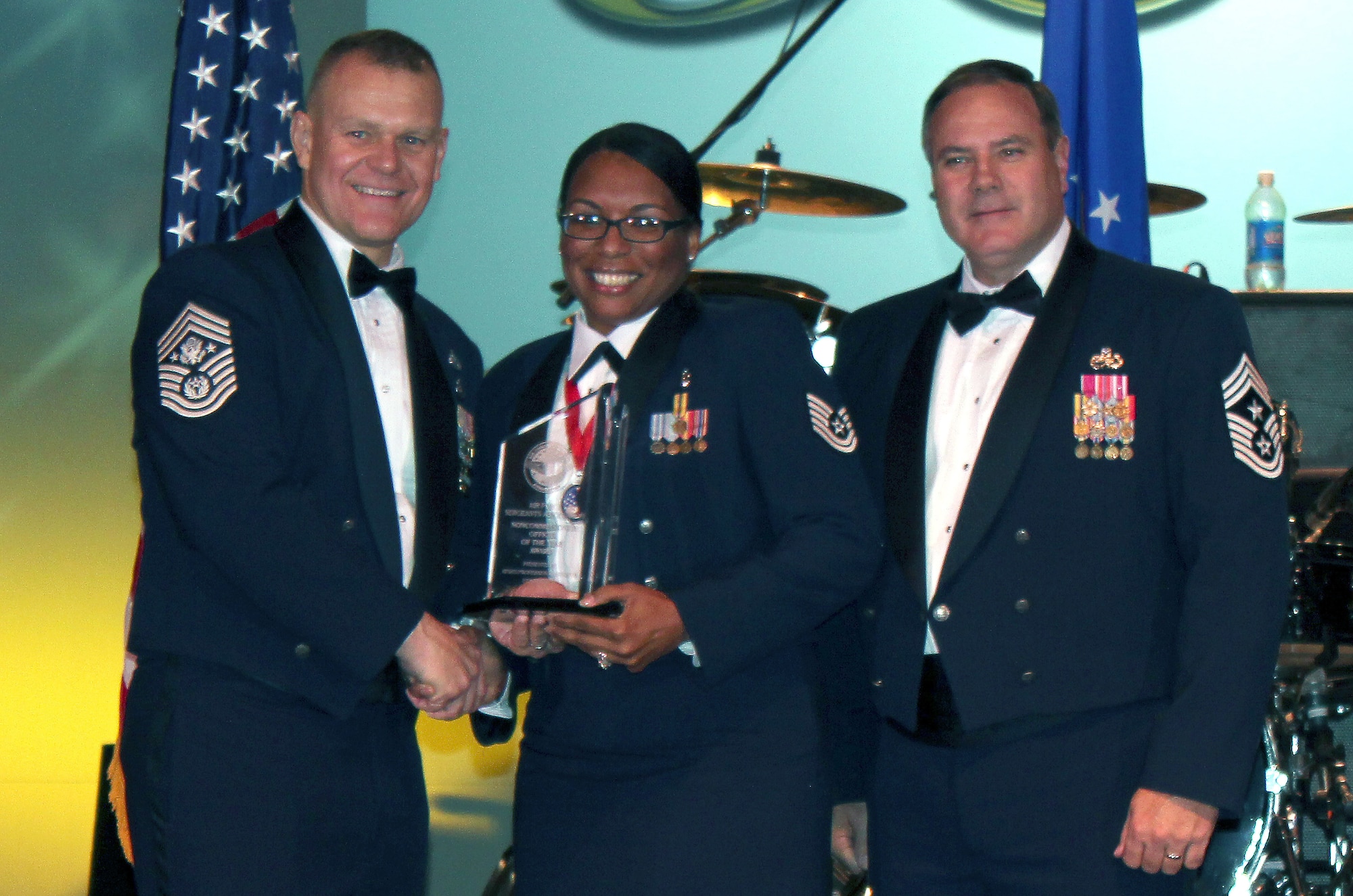 SEYMOUR JOHNSON AIR FORCE BASE, N.C. -- Recently-promoted Master Sgt. Nina Anderson receives the Air Force Sergeant’s Association International NCO of the Year Award from Chief Master Sgt. of the Air Force James Roy and retired Chief Master Sgt. Jeffrey Ledoux, AFSA International president, at the Professional Airmen’s Conference gala July 27, 2011, in San Antonio. (Courtesy photo)