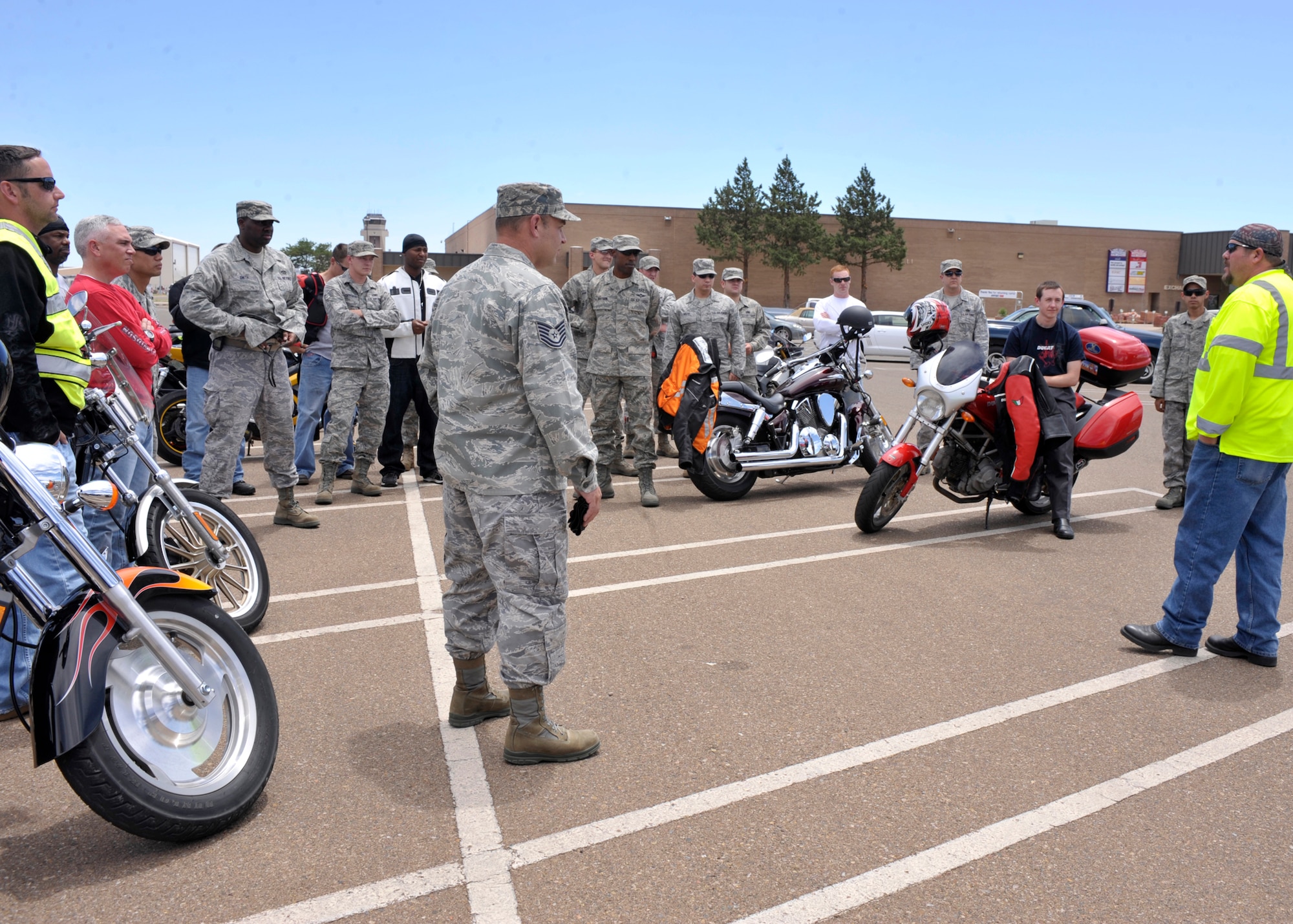 Brain Sapp, 27th Special Operations Civil Engineer Squadron, briefs a group of riders gathered for the motorcycle safety rally in the Base Exchange parking lot at Cannon Air Force Base, N.M., Aug. 1, 2011. Sapp is the co-creator of the 27th Special Operations Wing Rolling Eagles motorcycle riders group. (U.S. Air Force photo by Airman Ericka Engblom)