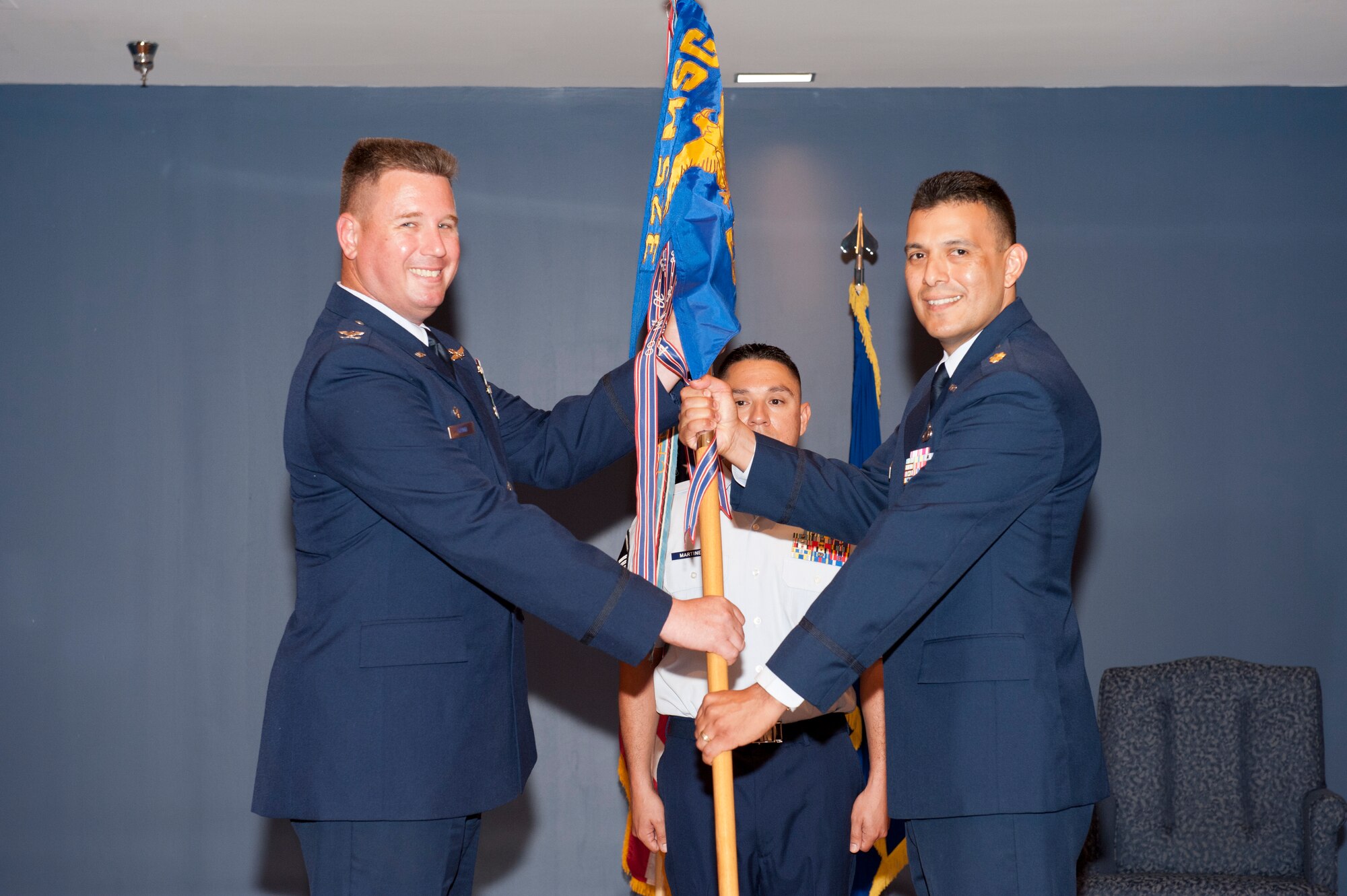 Colonel William Grund, 325th Mission Support Group commander, passes command of the 325th Contracting Squadron to Maj. Antonio Gonzalez during a change of command ceremony August 3. Major Gonzalez replaces Lt. Col. Jonathan Terry who departs Tyndall to serve as Chief, Electronic Warfare Contracting Branch, Robins Air Force Base, Ga. Major Gonzalez  arrives from Det. 1, 21st Contracting Squadron, U.S. Embassy, Copenhagen, Denmark. (U.S. Air Force photo by Lisa Norman)