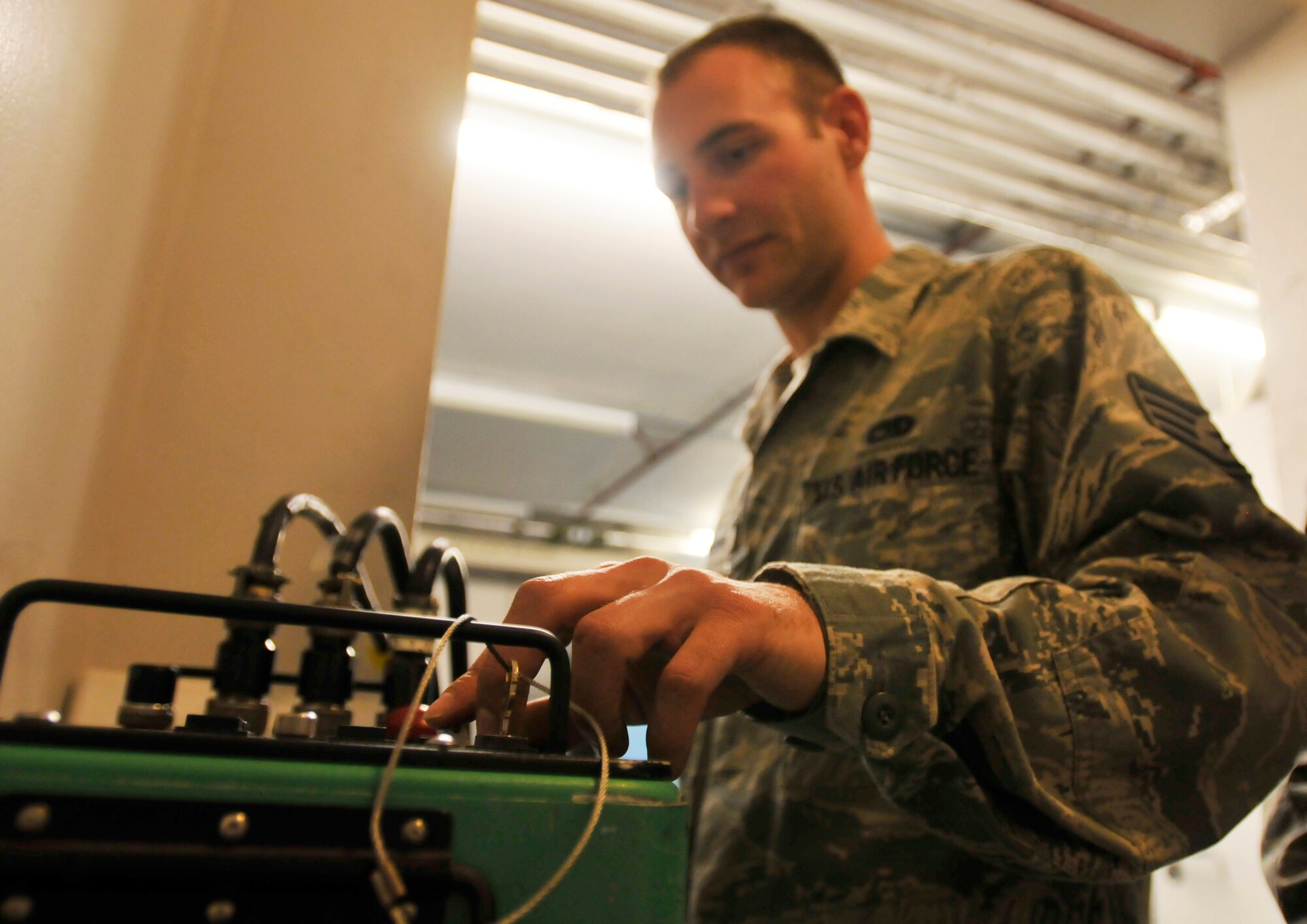 ROYAL AIR FORCE LAKENHEATH, England - Staff Sgt. Trevor Knapp, 48th Equipment Maintenance Squadron Nondestructive Inspection journeyman, presses a button to begin taking x-rays of an aircraft part at RAF Lakenheath, Aug. 2, 2011. Airmen from the NDI are responsible for finding the smallest aircraft defects so they can be repaired to prevent larger problems. (U.S. Air Force photo/Senior Airman Tiffany M. Deuel)