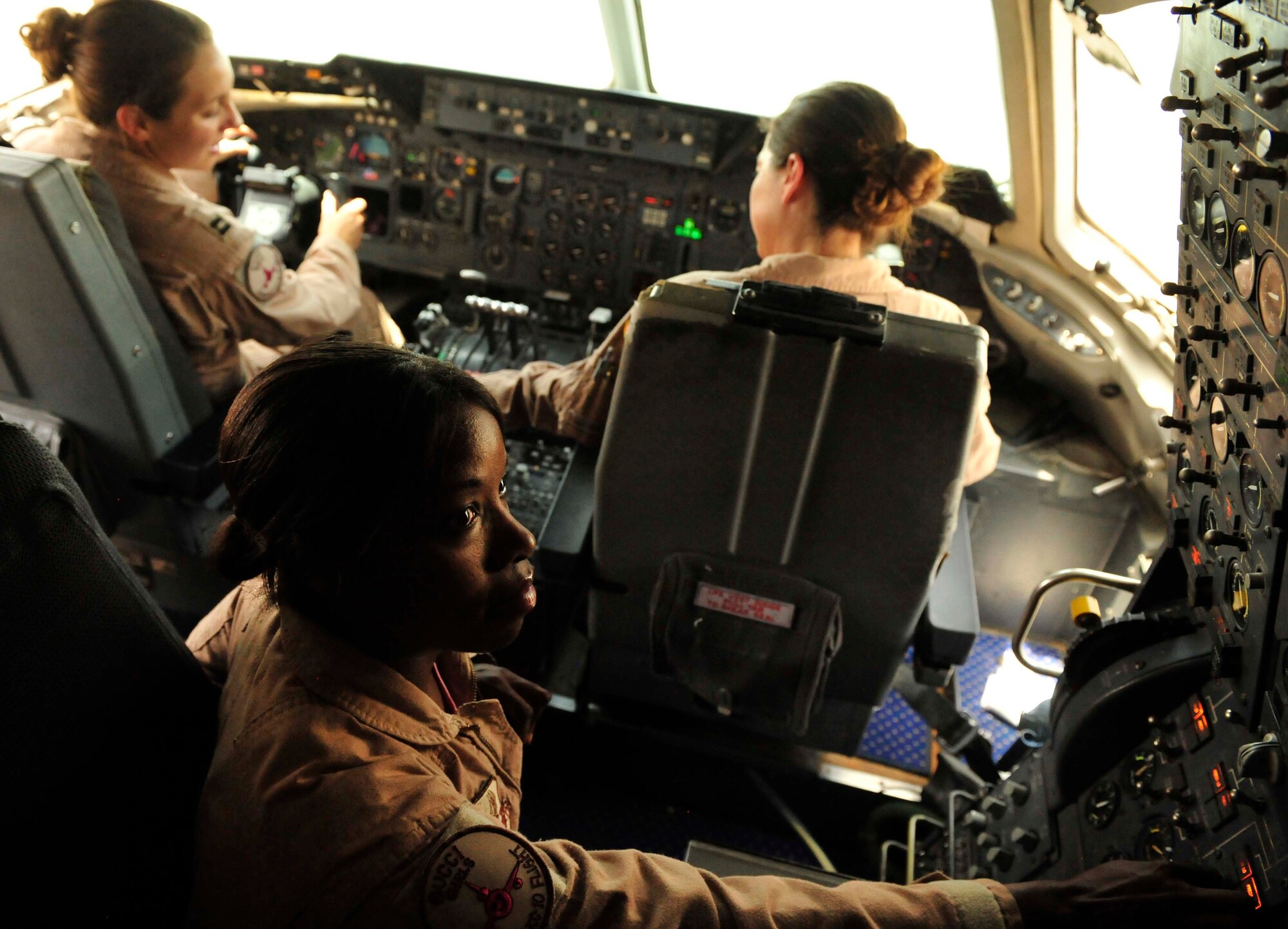 Capt. Lindsey Bauer, aircraft commander, 1st Lt. Jen Carter, pilot, and Staff Sgt. Sarah Lockley, flight engineer, from the 908th Expeditionary Air Refueling Squadron in Southwest Asia, participate in an “unmanned” aerial refueling mission in the KC-10 Extender, Aug. 2, 2011. The deployed environment admittedly is a mostly male world. For a day though, the deployed KC-10 crew made it an all-female day, as all four crew positions were held by females, truly making their mission "unmanned." This crew composition is rare because Lockley is the only female KC-10 flight engineer in the Air Force. (U.S. Air Force photo/Staff Sgt. Patrick Mitchell)