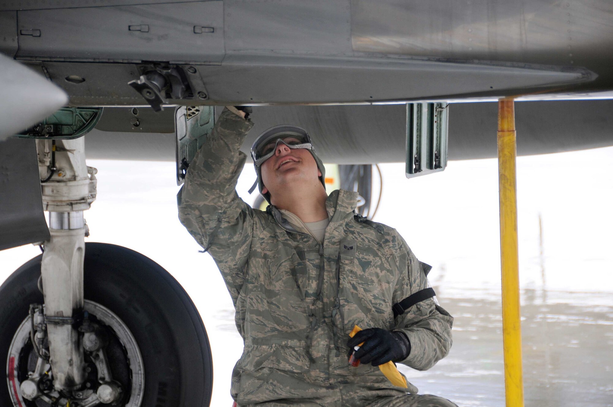 While deployed to Joint Base Elmendorf-Richardson, Alaska in support of a training exercise, SrA Kyle Bienia takes oil samples from the F-15 Eagle for the Joint Oil Analysis Program (JOAP).  This program identifies wear metals present in the sample and their probable sources.  This information is used to proactively evaluate the aircraft's condition.(U.S.A.F. photograph by Technical Sergeant, Anthony M. Mutti)