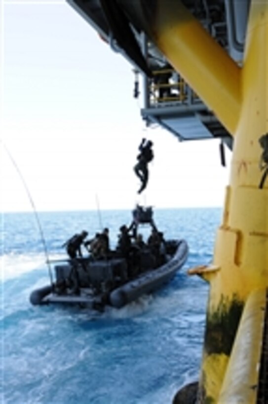 U.S. Navy SEALs train with Special Boat Team 12 on the proper techniques of how to board gas and oil platforms from a moving vessel near Long Beach, Calif., on July 28, 2011.  SEALs conduct these exercises to hone their various maritime operations skills.  