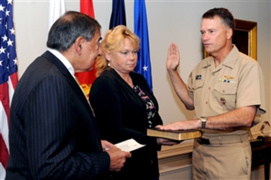 Secretary of Defense Leon E. Panetta swears in Adm. James A. Winnefeld Jr. as the new Vice Chairman of the Joint Chiefs of Staff during a ceremony conducted in Panetta's Pentagon office on Aug. 4, 2011.  Winnefeld's wife Mary holds the Bible.  
