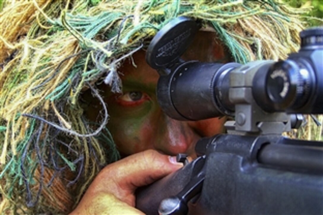 U.S. Air Force Senior Master Sgt. Nathan Brett practices a scenario on a range during Air Mobility Rodeo 2011 on Joint Base Lewis-McChord, Wash., July 27, 2011. Brett, a sniper-qualified airman, is the superintendent of the U.S. Air Force Expeditionary Center's 421st Combat Training Squadron at Joint Base McGuire-Dix-Lakehurst, N.J. The event was part of Air Mobility Rodeo 2011, a biennial international competition that focuses on mission readiness.