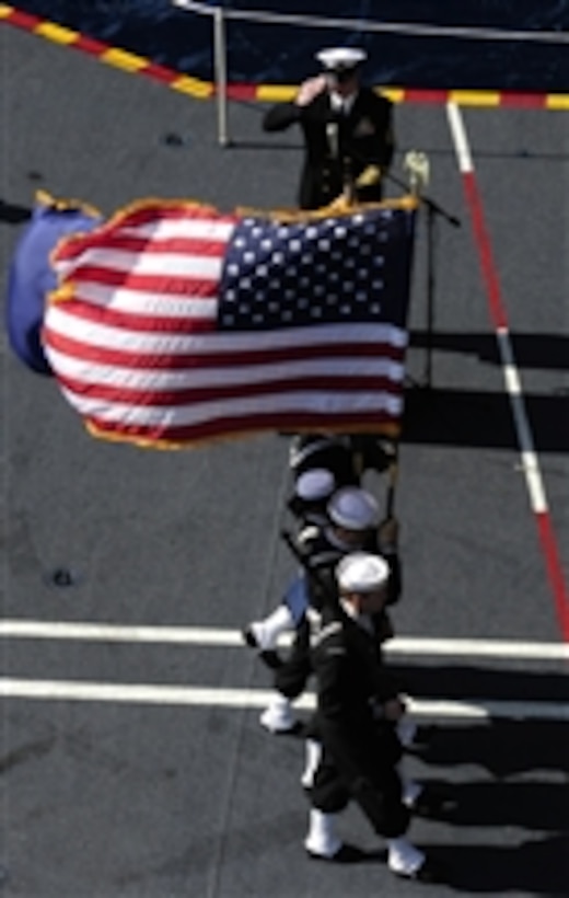 Members of the color guard aboard the aircraft carrier USS John C. Stennis (CVN 74) parade the colors during a burial at sea while underway in the Pacific Ocean on Aug. 1, 2011.  The John C. Stennis Carrier Strike Group is on a western Pacific Ocean and Arabian Gulf deployment.  