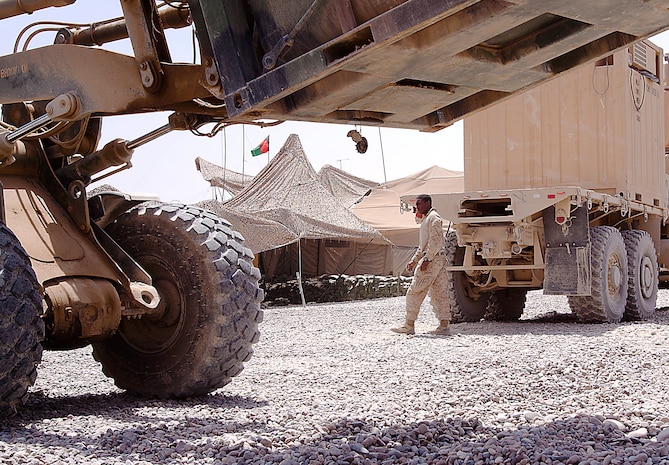 Lance Cpl. Ryan Shephard fastens the locking mechanisms on his truck to a giant freezer at Patrol Base May, Aug. 4. Shephard, a native of Olathe, Kan., is a driver and gunner for 3rd Trucks Platoon. Originating from Marine Corps Bases Japan, 3rd Trucks Platoon is attached to 1st Battalion, 3rd Marine Regiment. Trucks Platoon is responsible for logistical deliveries throughout 1/3’s area of operations.